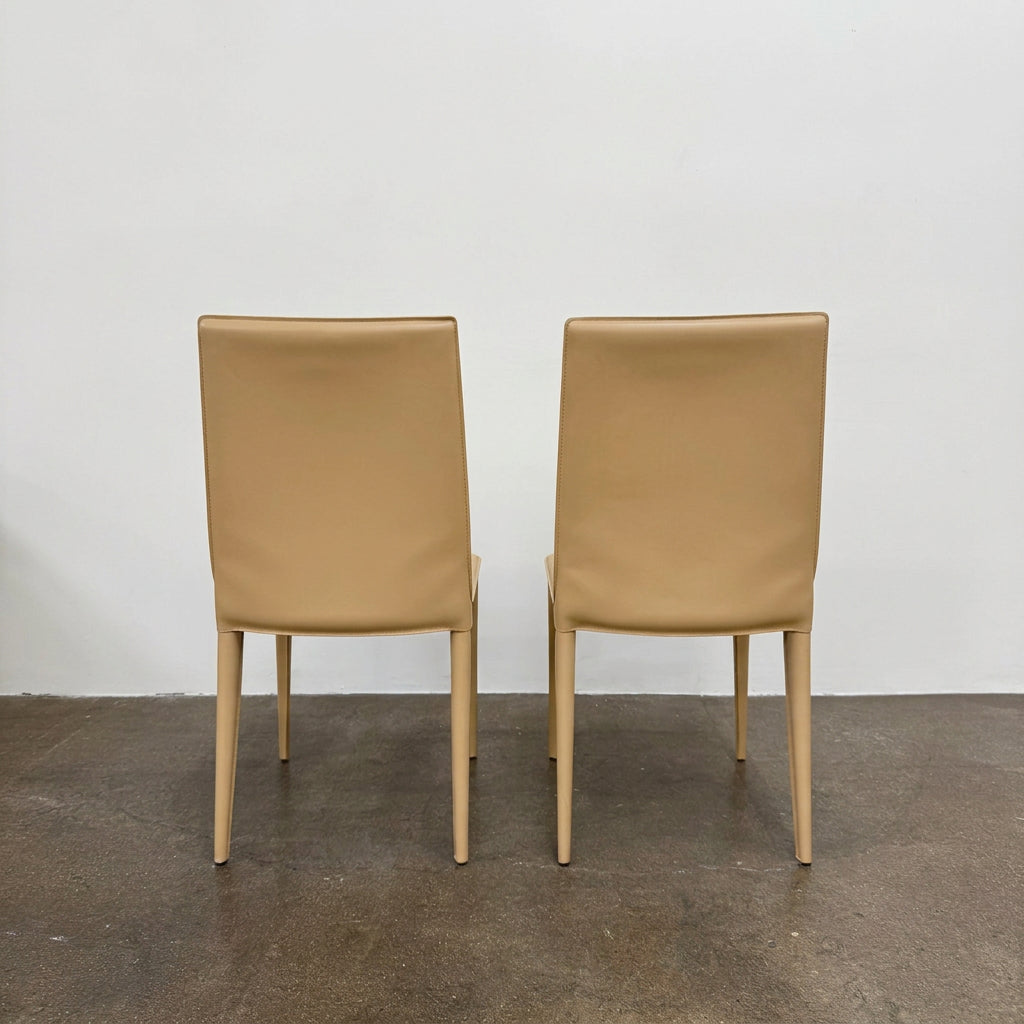Eight light-tan Frag Bottega leather dining chairs arranged in two rows.