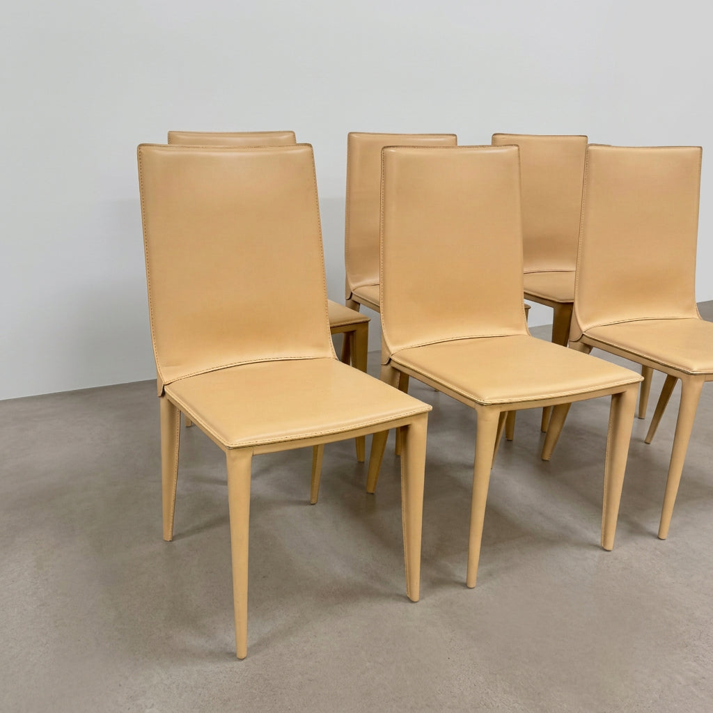 Eight light-tan Frag Bottega leather dining chairs arranged in two rows.