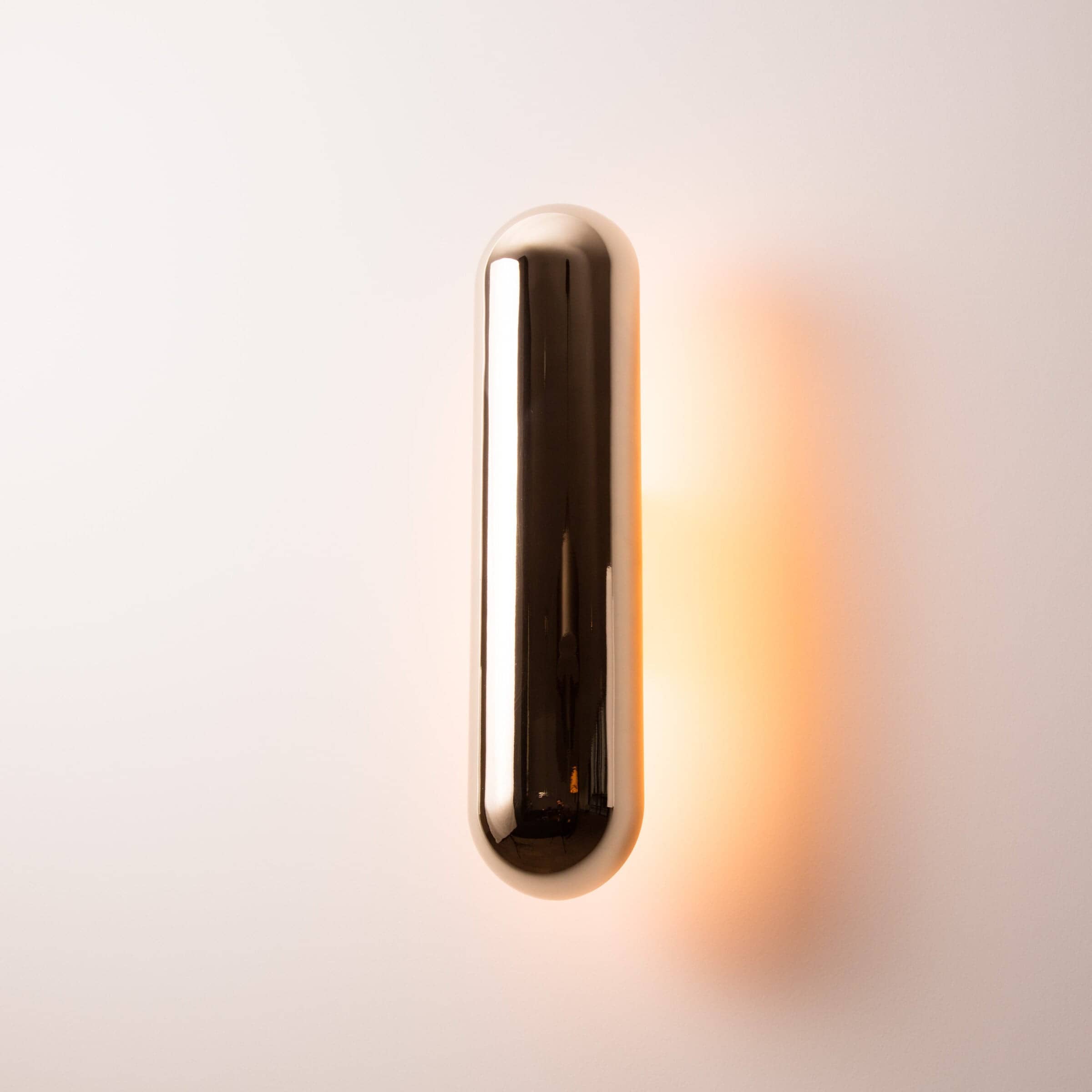 A pair of Ozone Gélule wall sconces on a white background, offering timeless elegance and sophisticated lighting solutions.