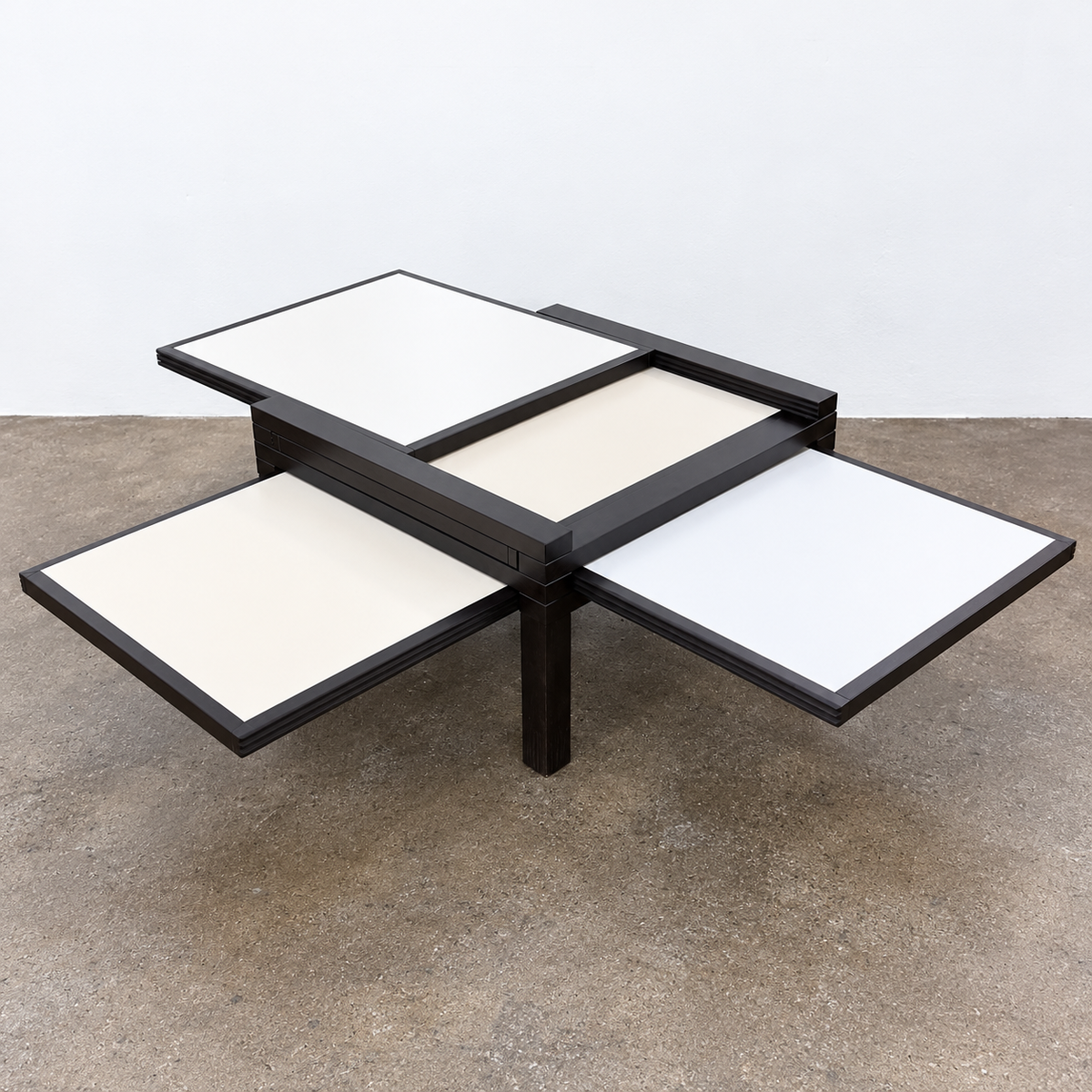 Bellato Hexa Expandable Coffee Table featuring an 1980s-style solid wood frame with multiple white and cream sliding panels extending from the center.
