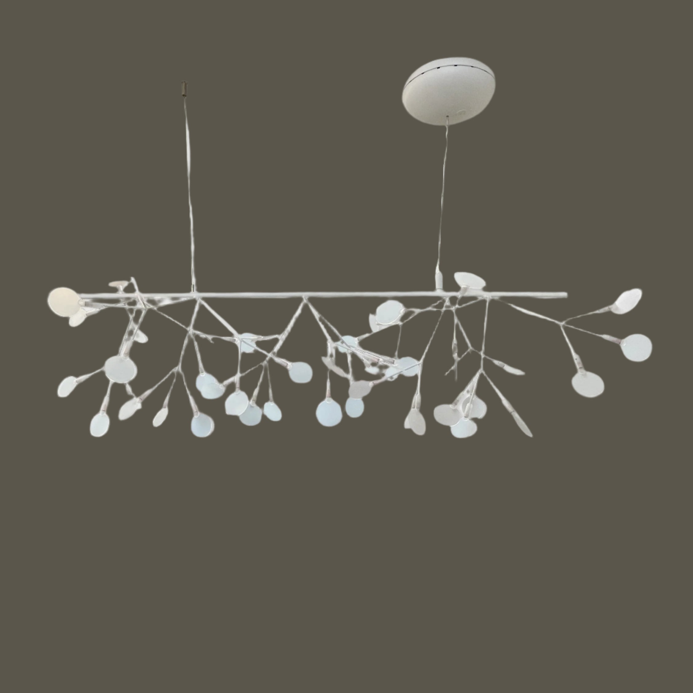 The Moooi Heracleum Endless LED Suspension Lamp-White is a modern chandelier featuring multiple radial branches ending in circular light diffusers, hanging from a single cord attached to a round ceiling mount.