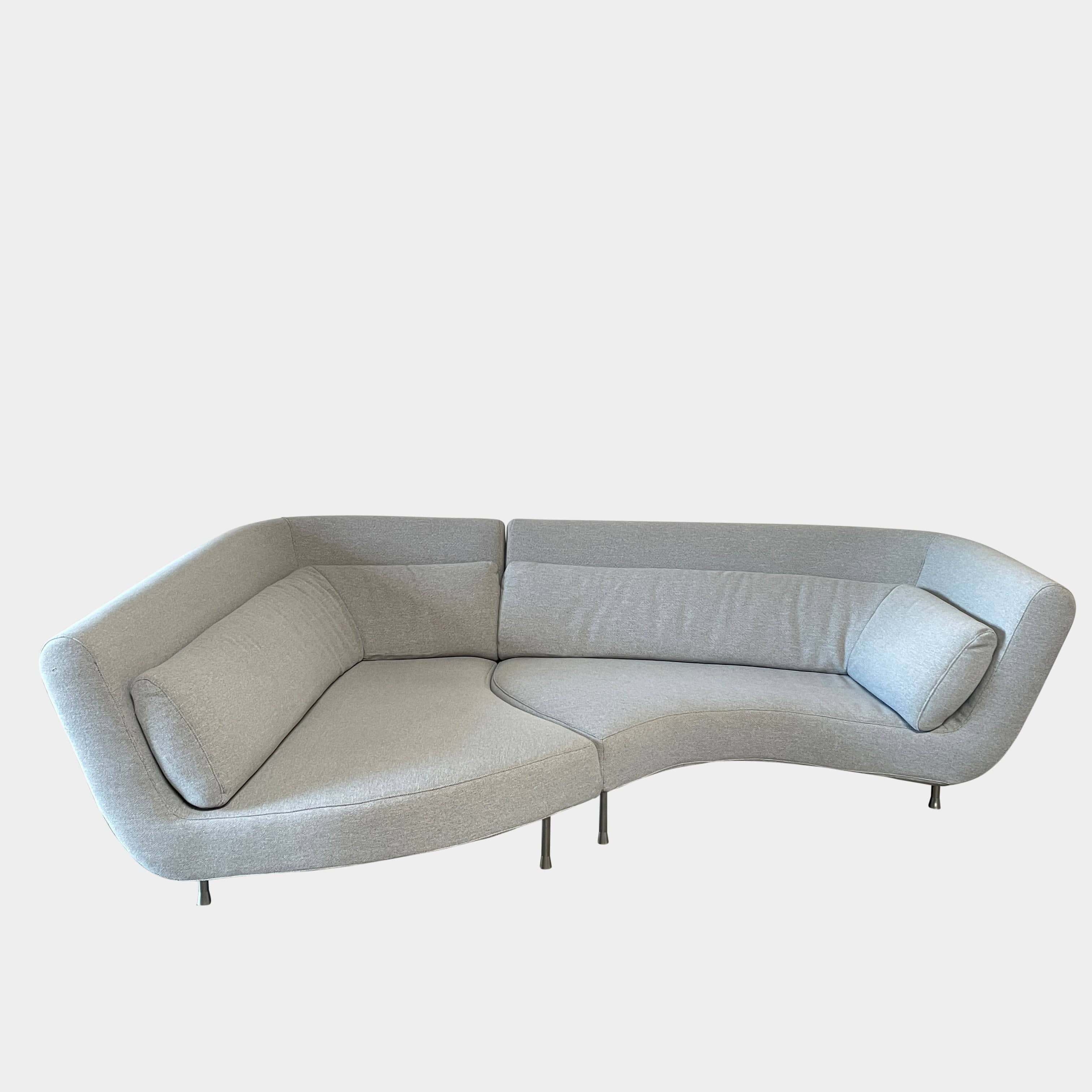 Modern curved Ligne Roset Yang Sectional sofa in durable wool fabric, isolated on a white background.