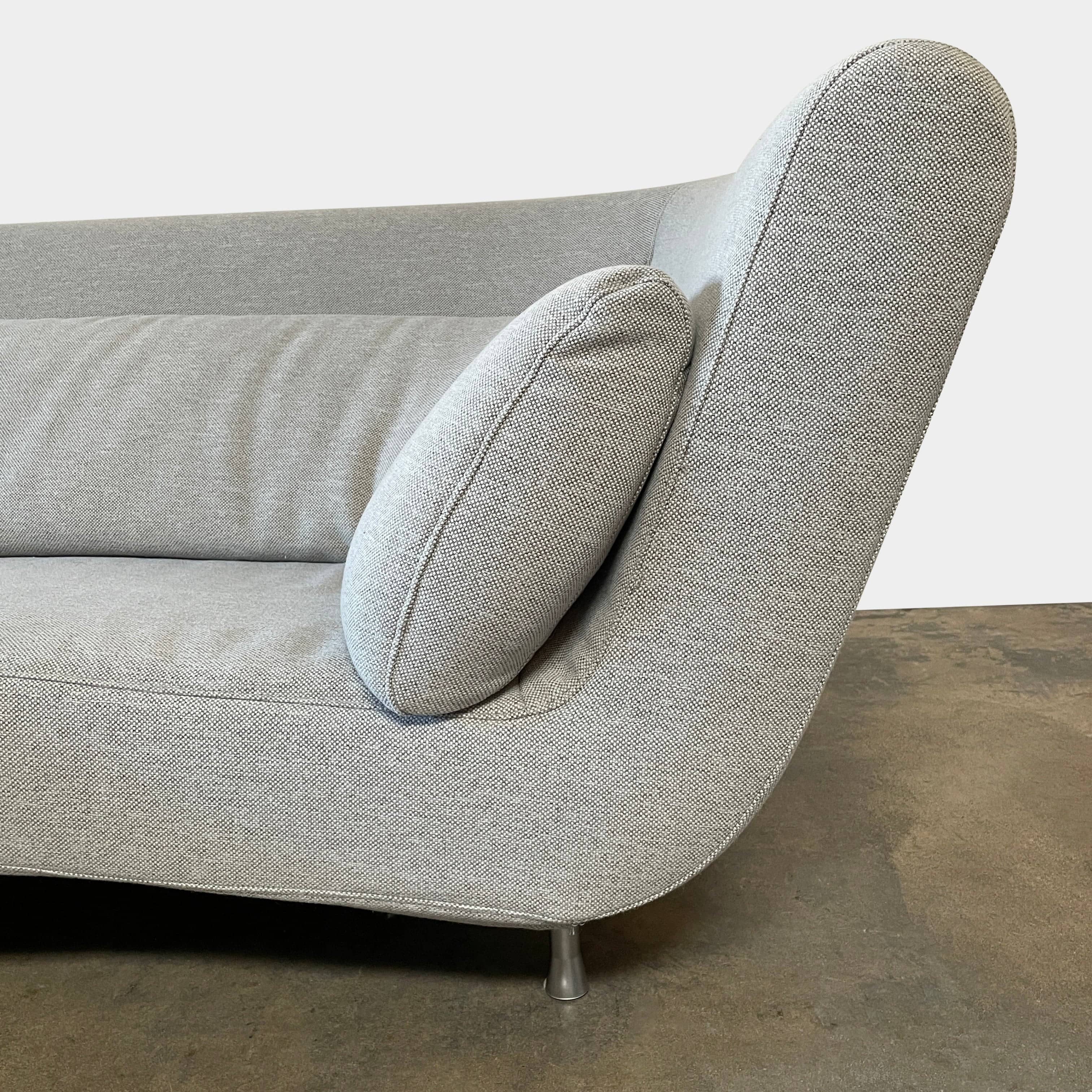 Modern curved Ligne Roset Yang Sectional sofa in durable wool fabric, isolated on a white background.