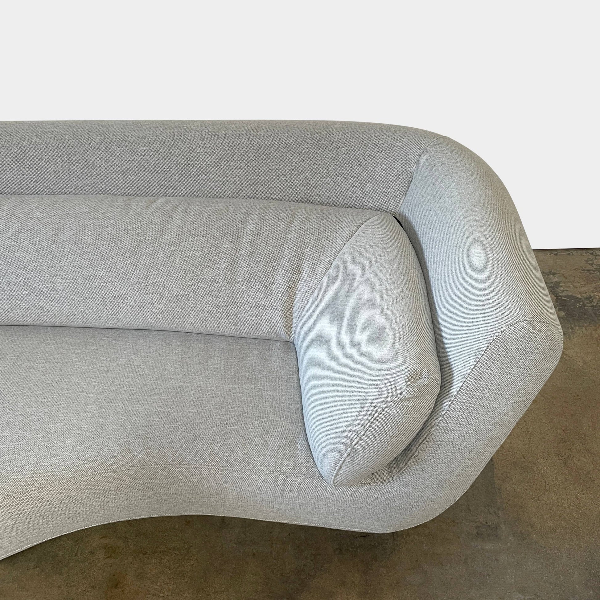 Modern curved Ligne Roset Yang Sectional sofa in durable wool fabric, isolated on a white background.