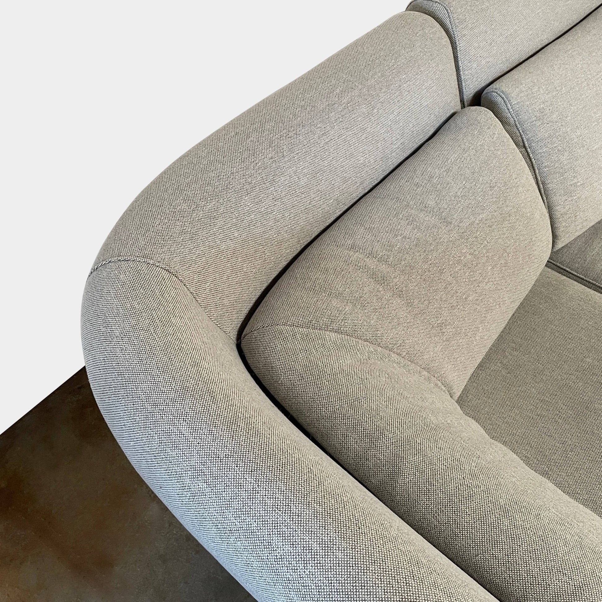 Modern curved Ligne Roset Yang Sectional sofa in durable wool fabric, isolated on a white background.