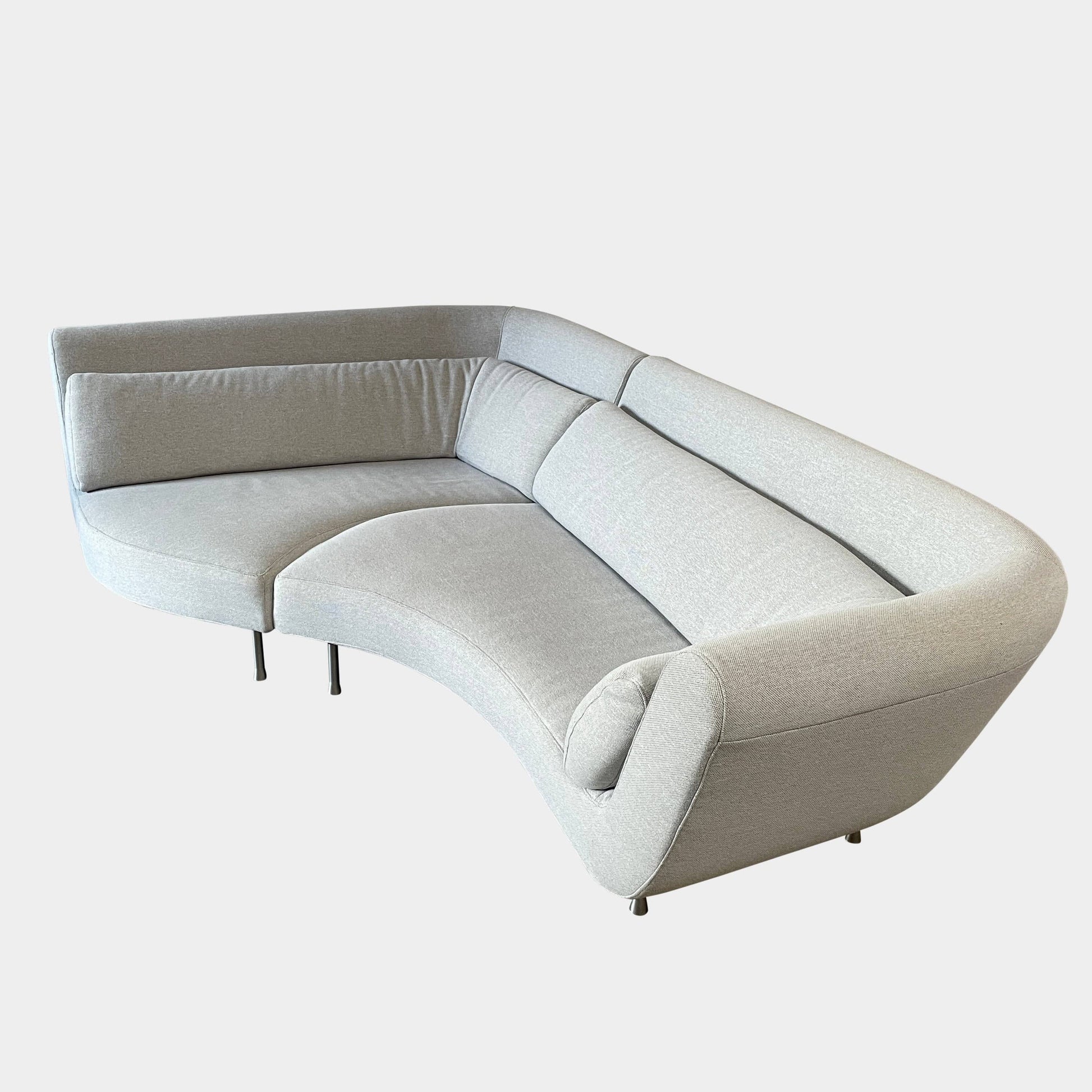 Modern curved Ligne Roset Yang Sectional sofa in durable wool fabric, isolated on a white background.