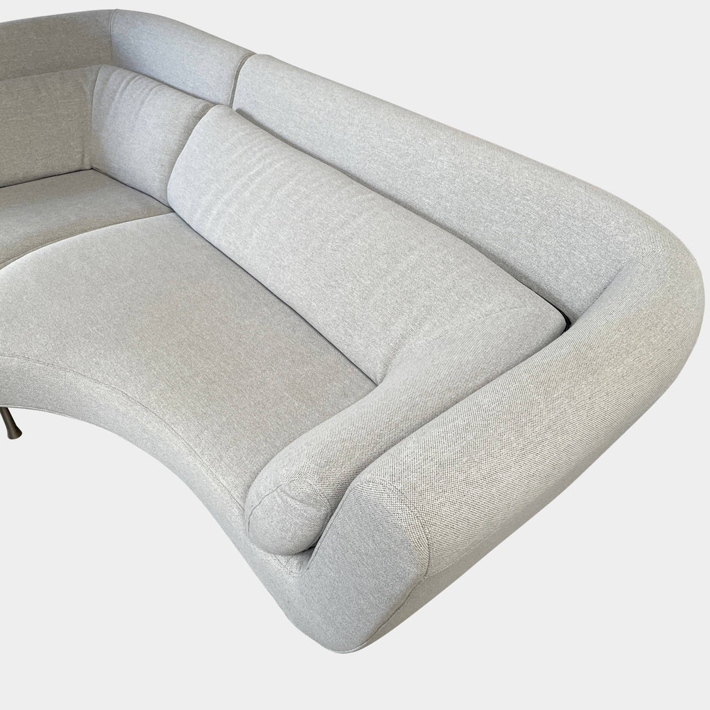 Modern curved Ligne Roset Yang Sectional sofa in durable wool fabric, isolated on a white background.