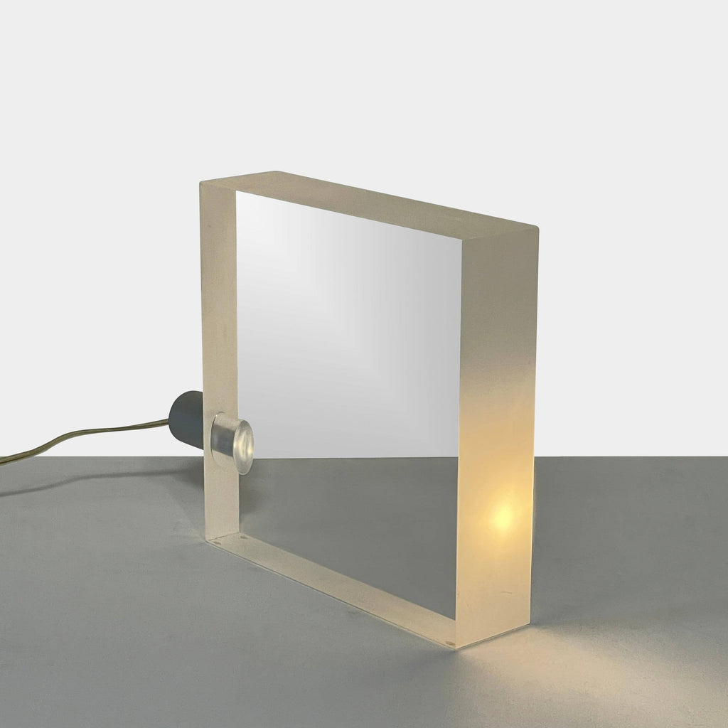 The Yamagiwa ToFU Table Lights, designed by Tokujin Yoshioka, are stylish square metal lamps featuring an innovative wire attachment.