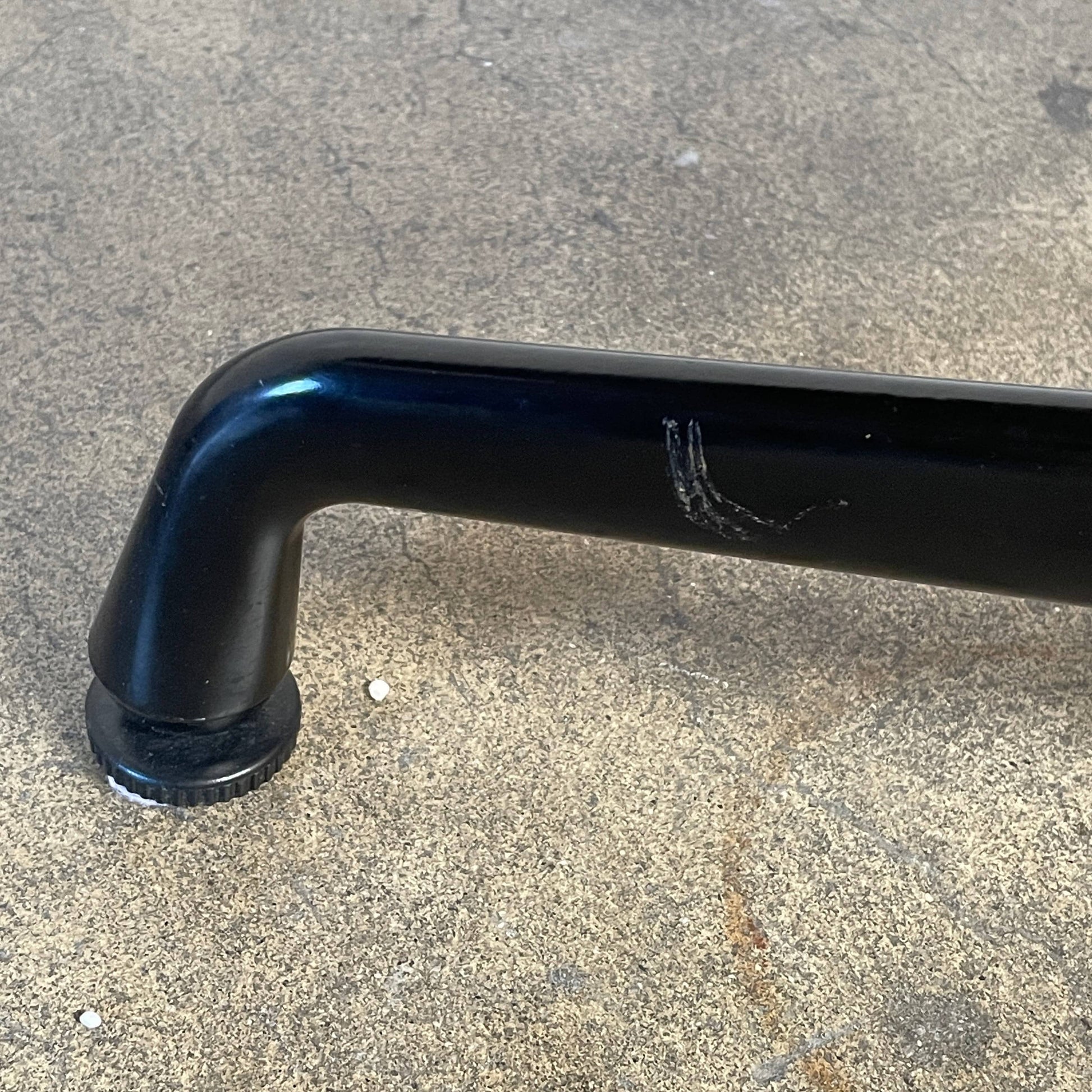 A Herman Miller Square Table with a black base and wooden top by Herman Miller.