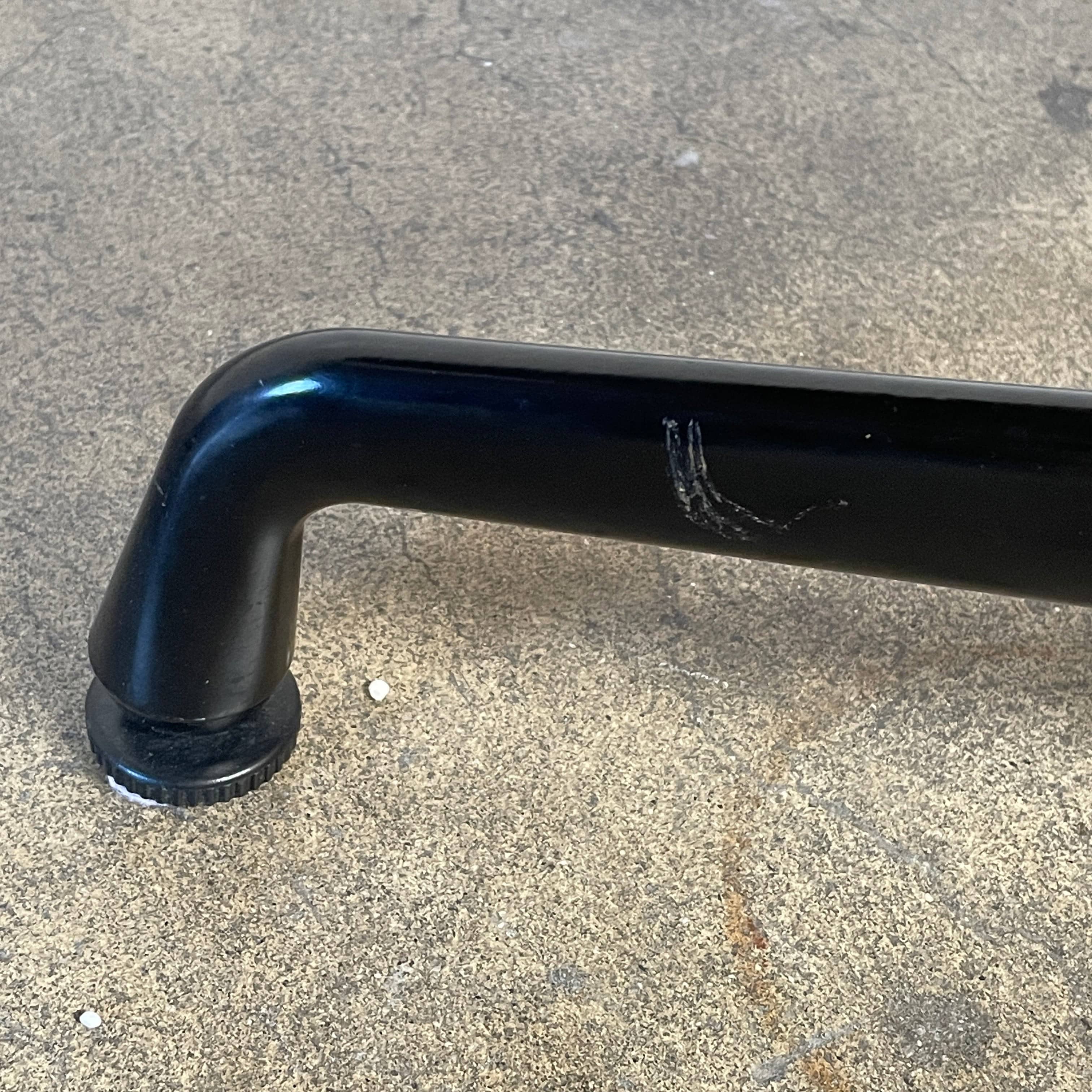 A Herman Miller Square Table with a black base and wooden top by Herman Miller.