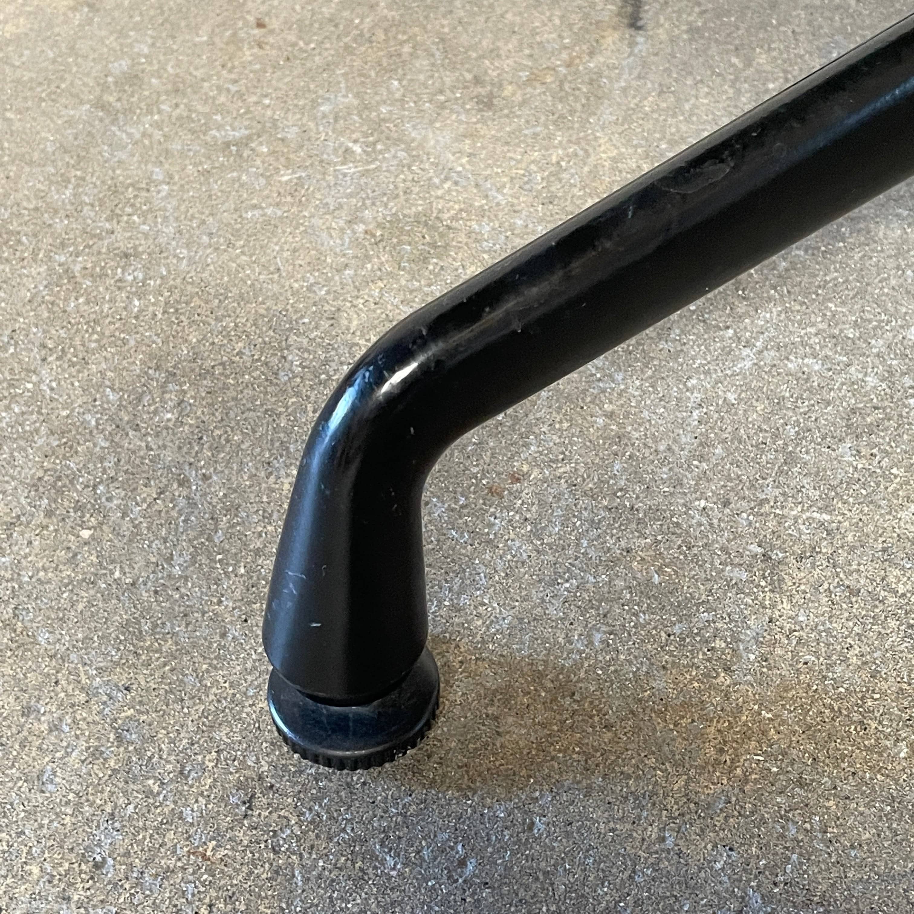 A Herman Miller Square Table with a black base and wooden top by Herman Miller.