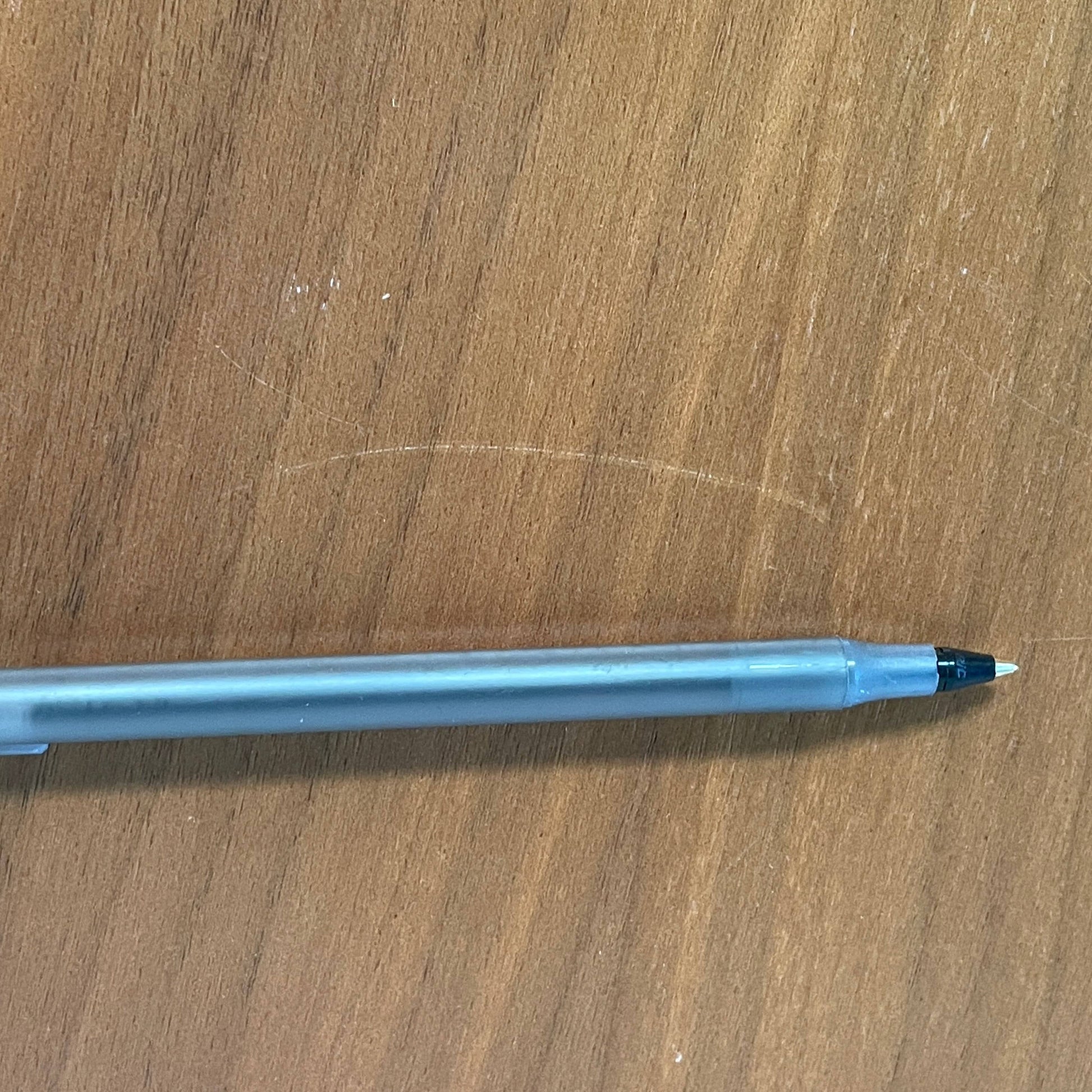 A Herman Miller Square Table with a black base and wooden top by Herman Miller.