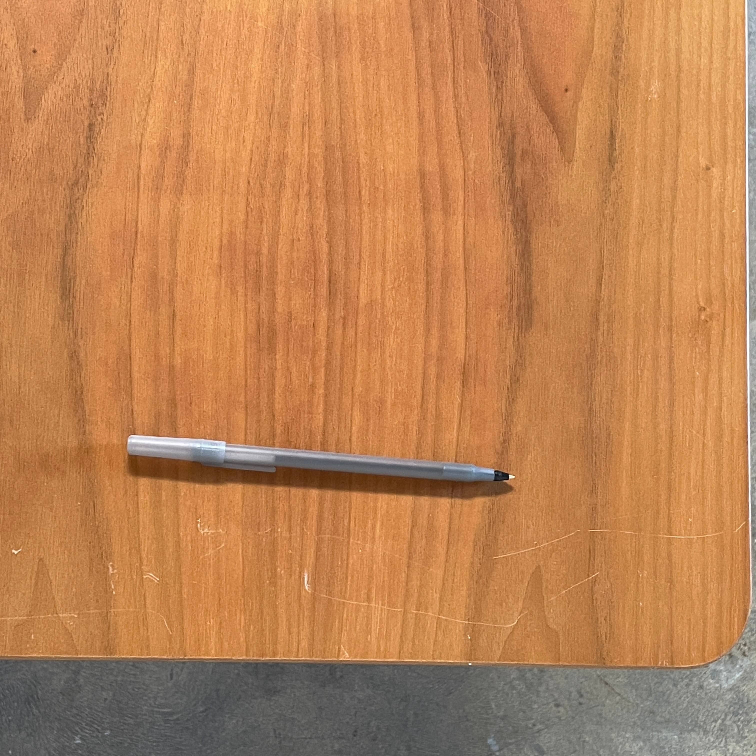 A Herman Miller Square Table with a black base and wooden top by Herman Miller.