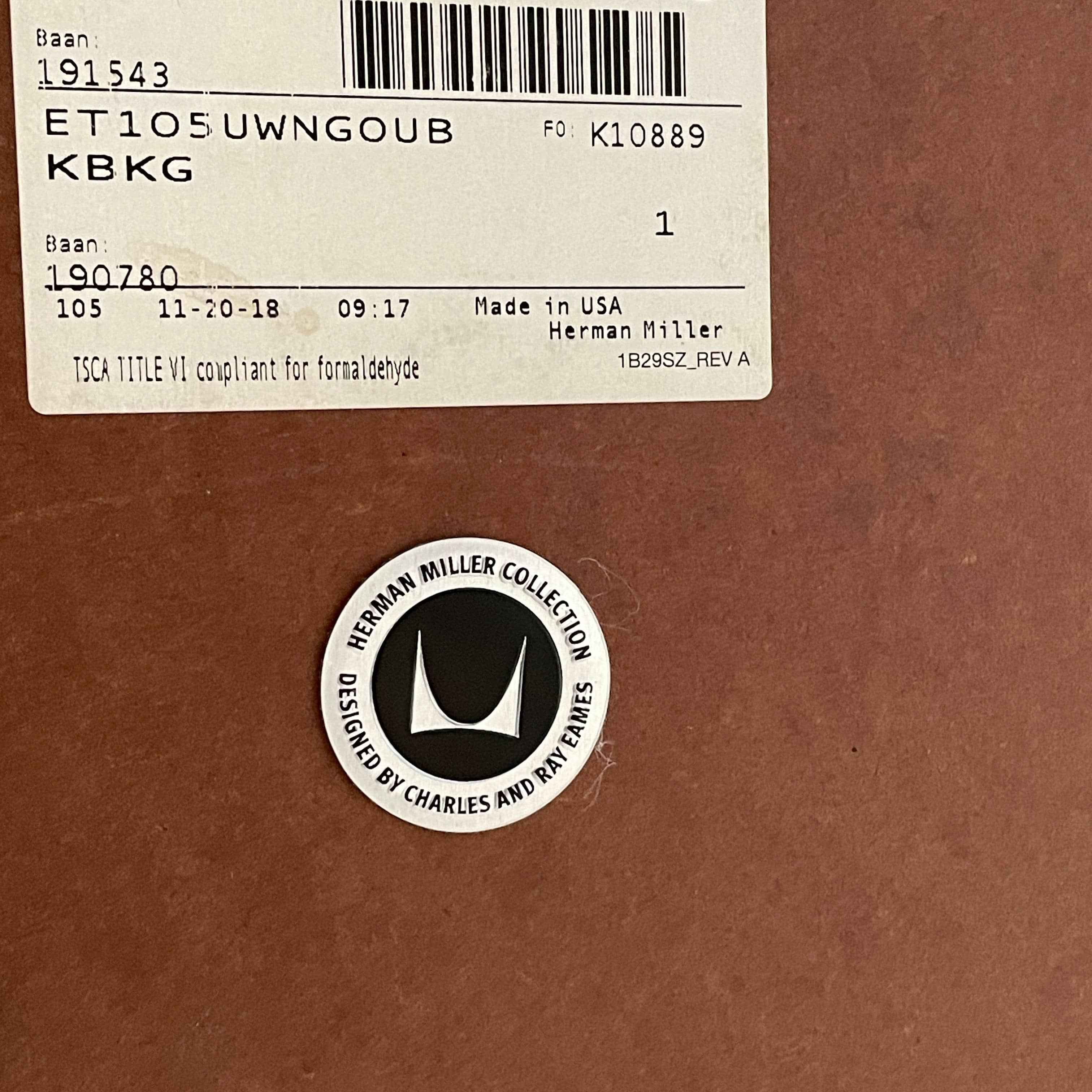 A Herman Miller Square Table with a black base and wooden top by Herman Miller.