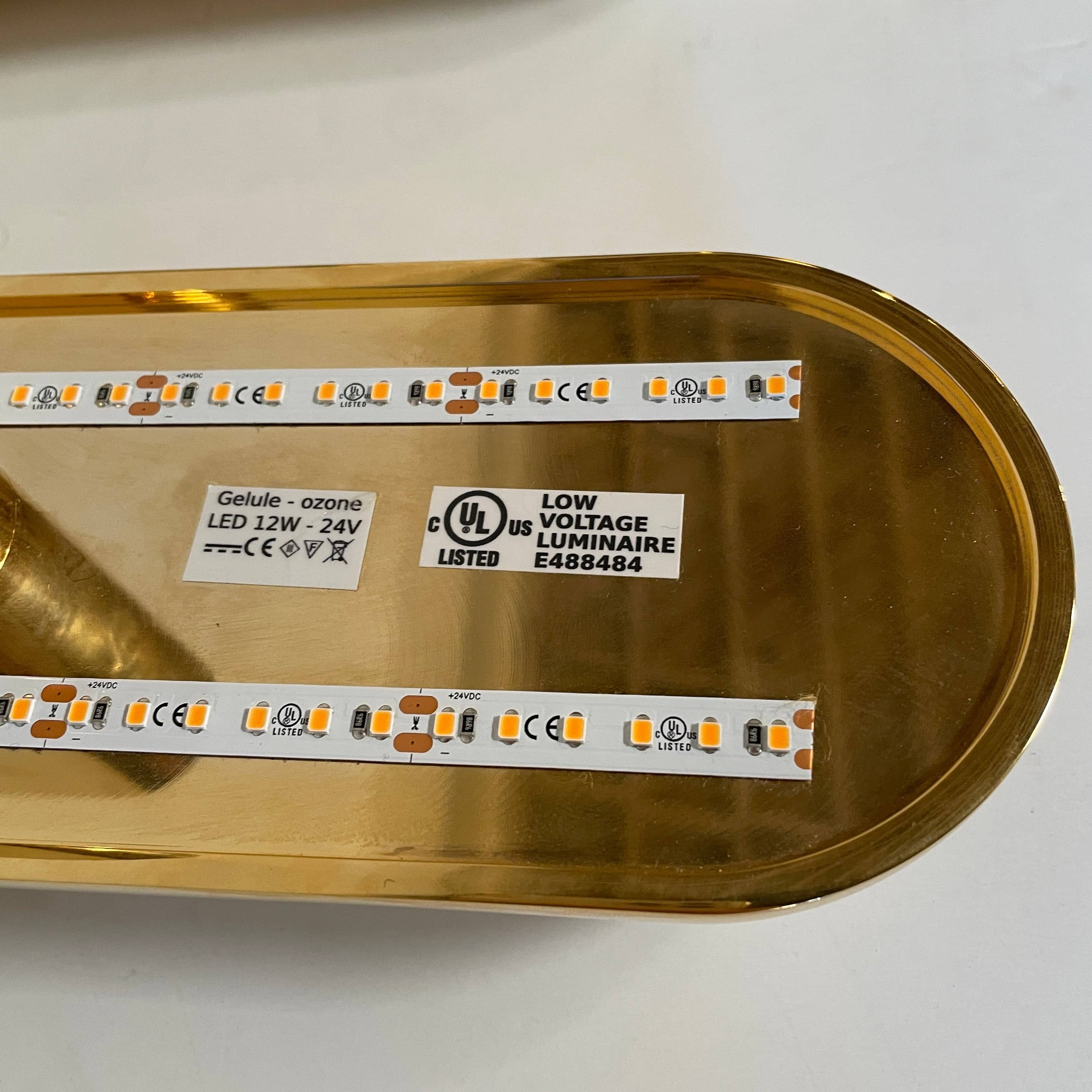 A pair of Ozone Gélule wall sconces on a white background, offering timeless elegance and sophisticated lighting solutions.