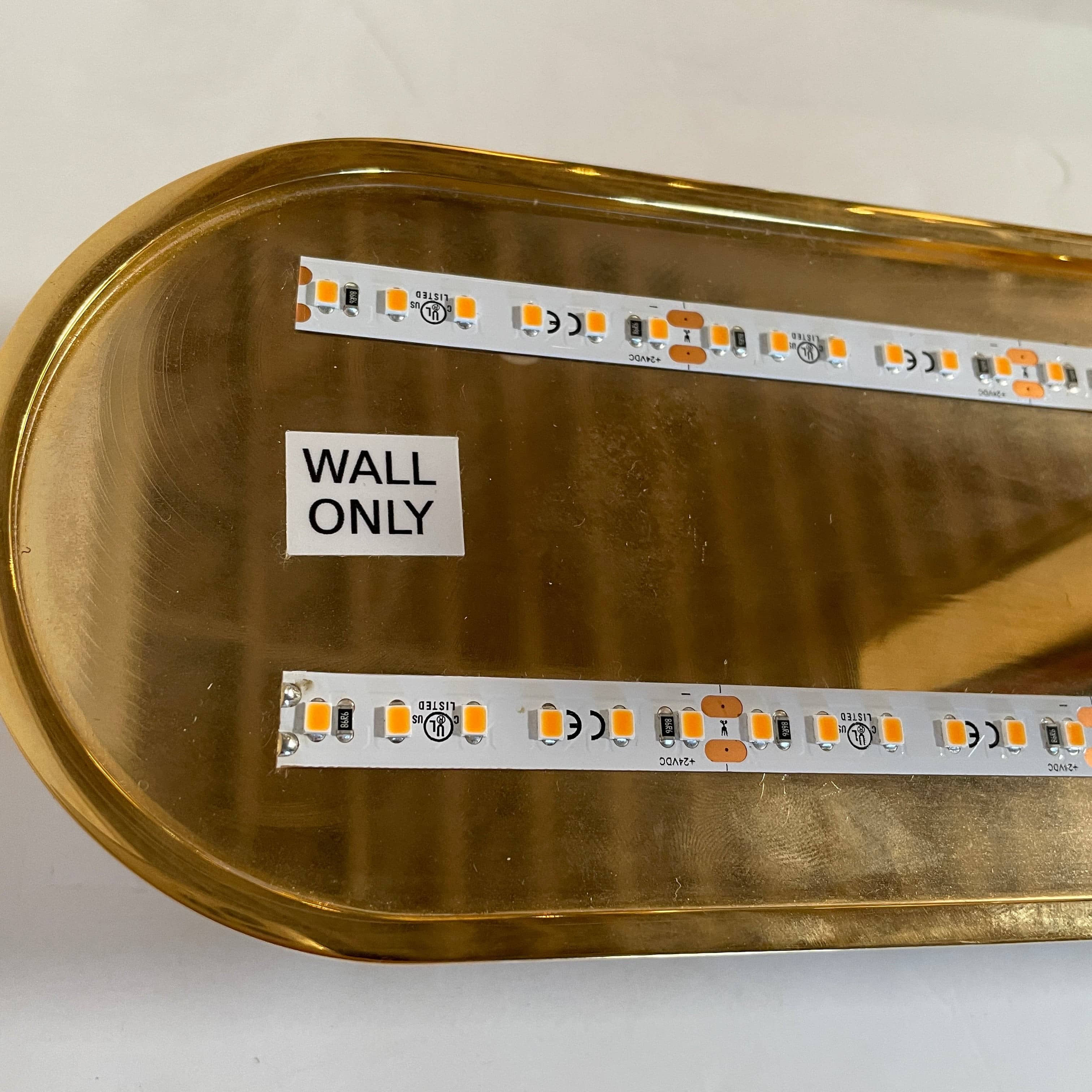 A pair of Ozone Gélule wall sconces on a white background, offering timeless elegance and sophisticated lighting solutions.