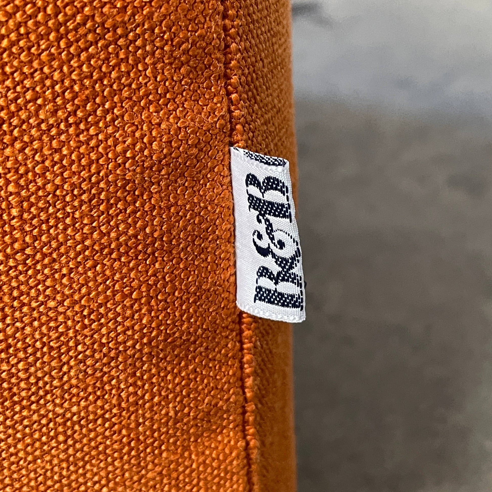 A small B&B Italia P60 ottoman on a white background.