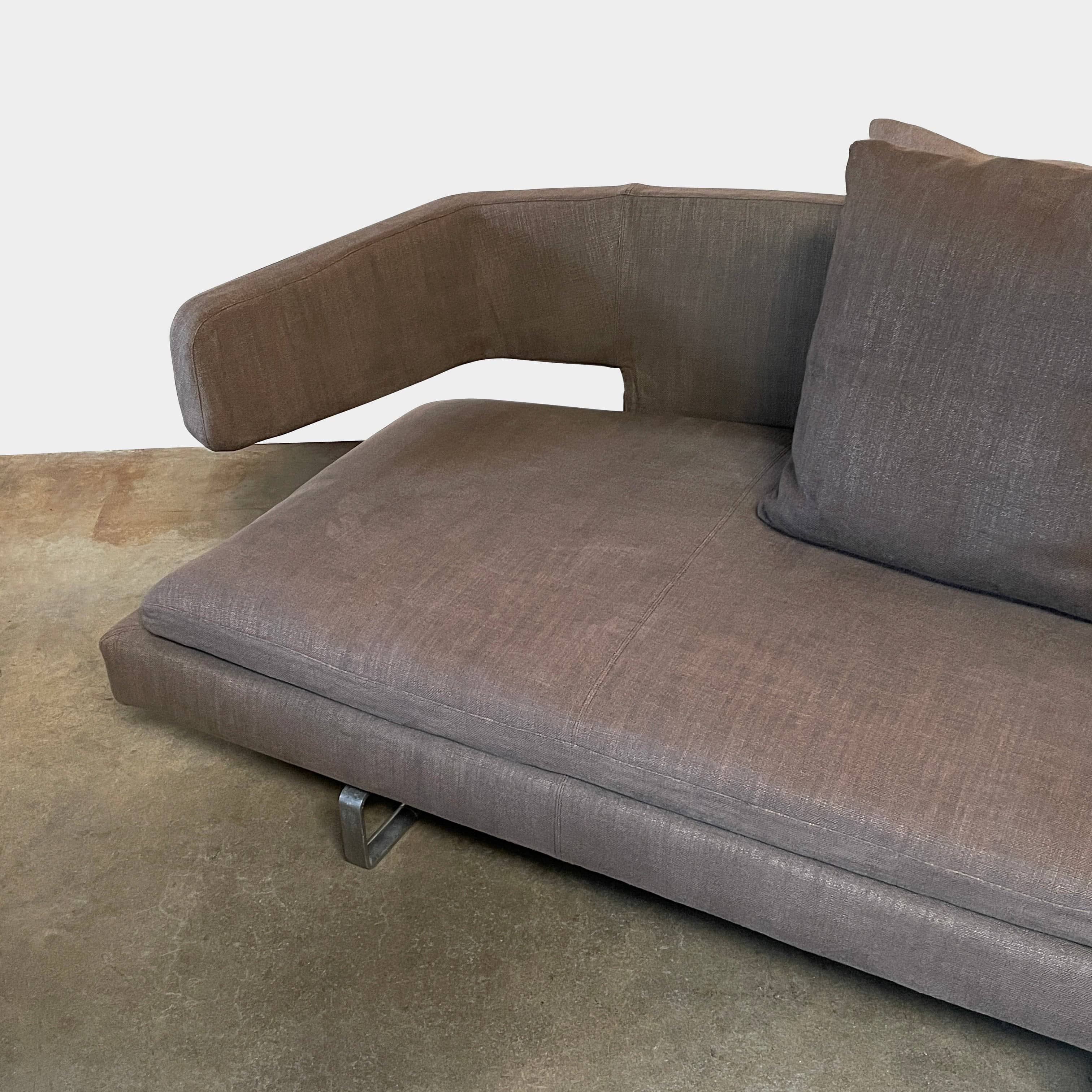 Modern upholstered l-shaped sectional B&B Italia Arne Sofa designed by Antonio Citterio, with cushions on a white background.