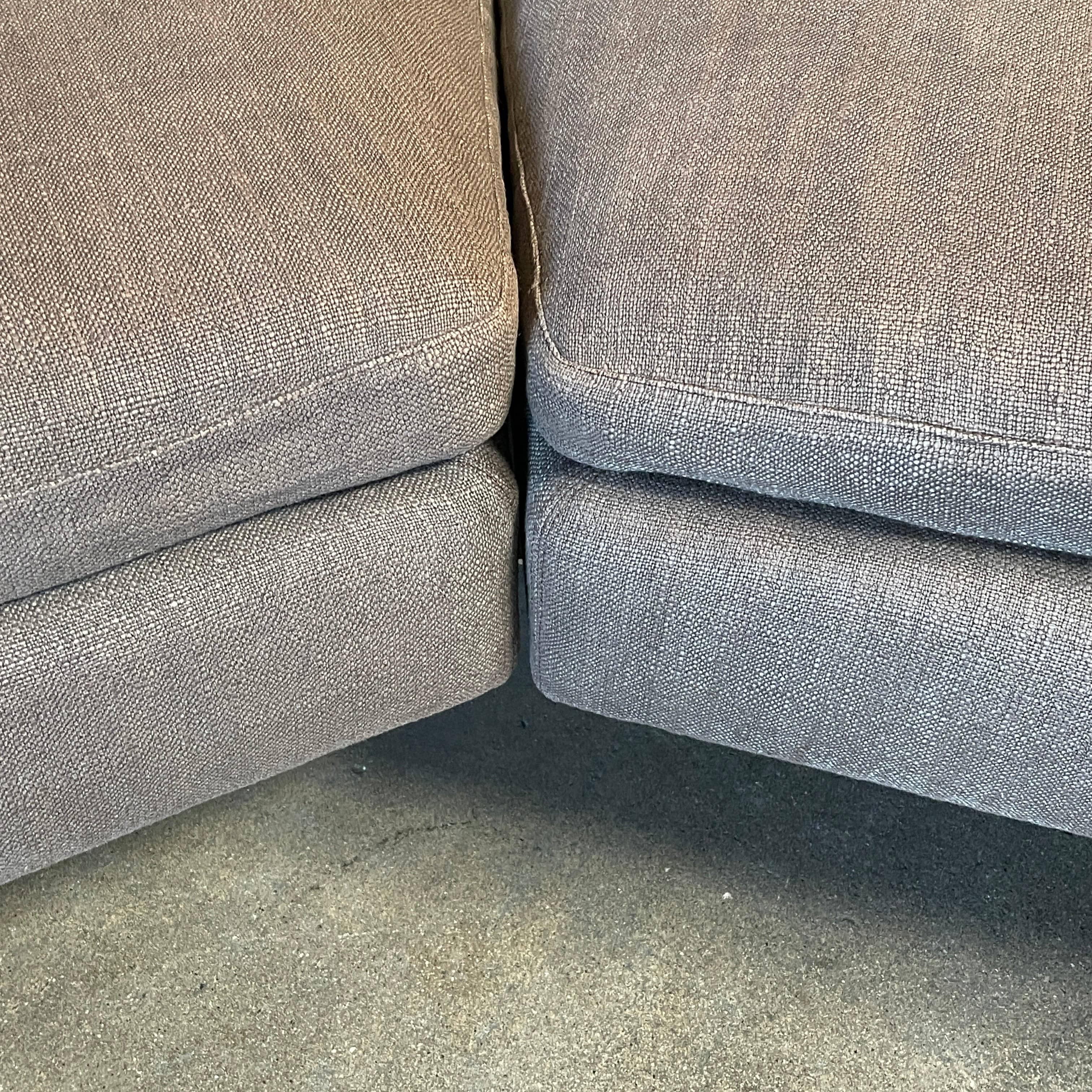 Modern upholstered l-shaped sectional B&B Italia Arne Sofa designed by Antonio Citterio, with cushions on a white background.