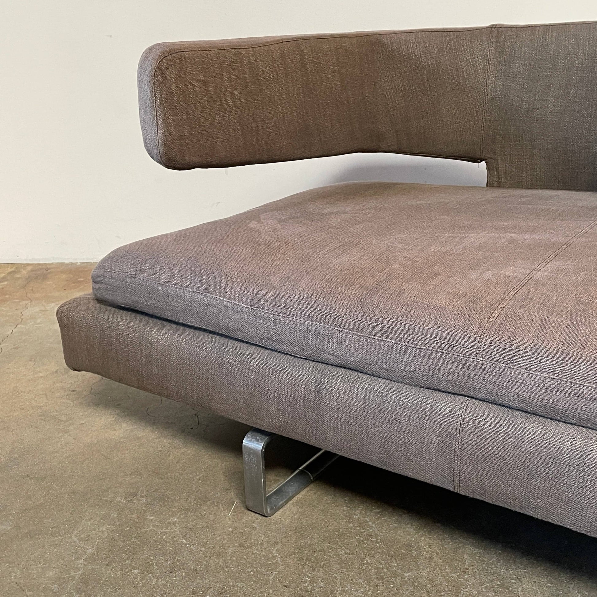 Modern upholstered l-shaped sectional B&B Italia Arne Sofa designed by Antonio Citterio, with cushions on a white background.