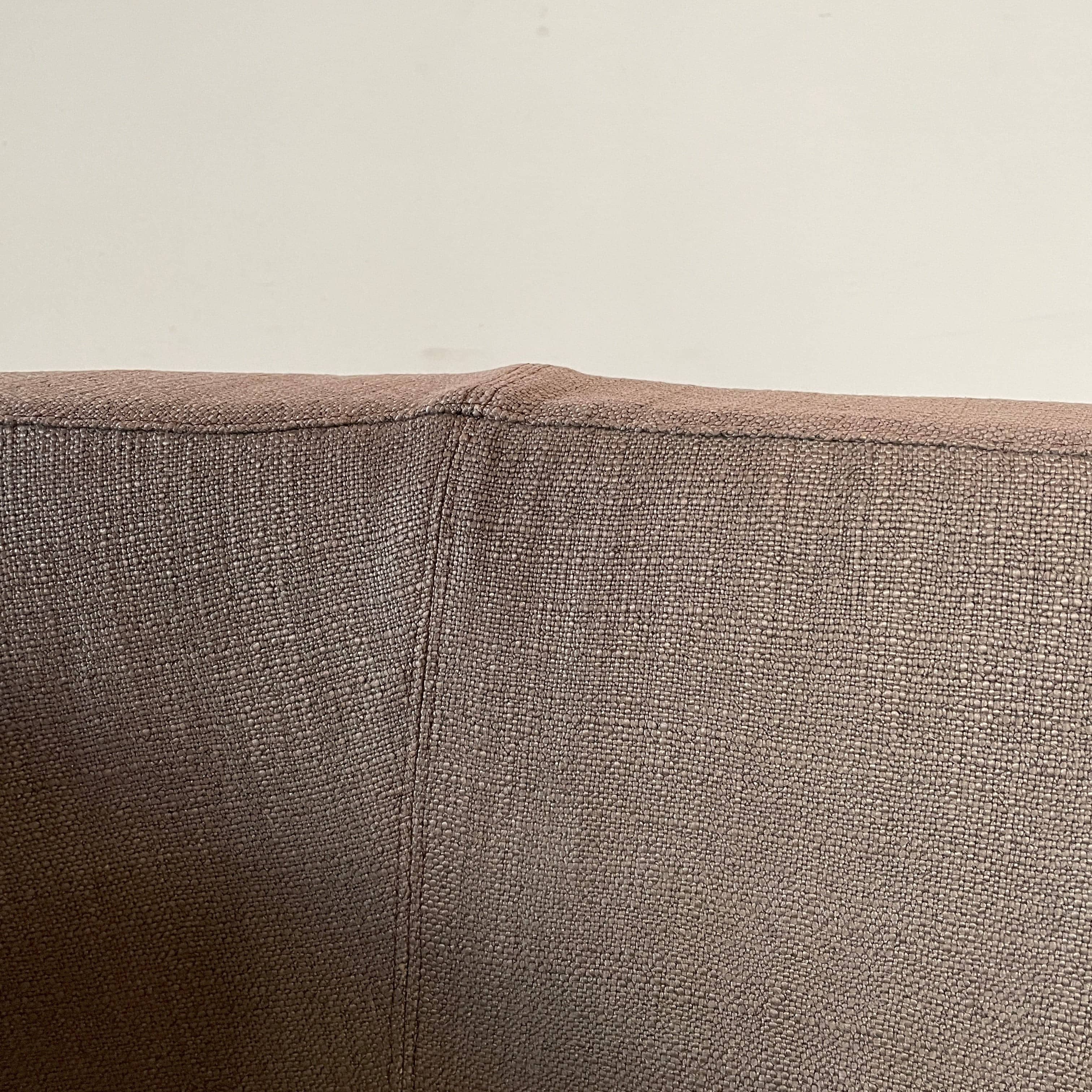 Modern upholstered l-shaped sectional B&B Italia Arne Sofa designed by Antonio Citterio, with cushions on a white background.