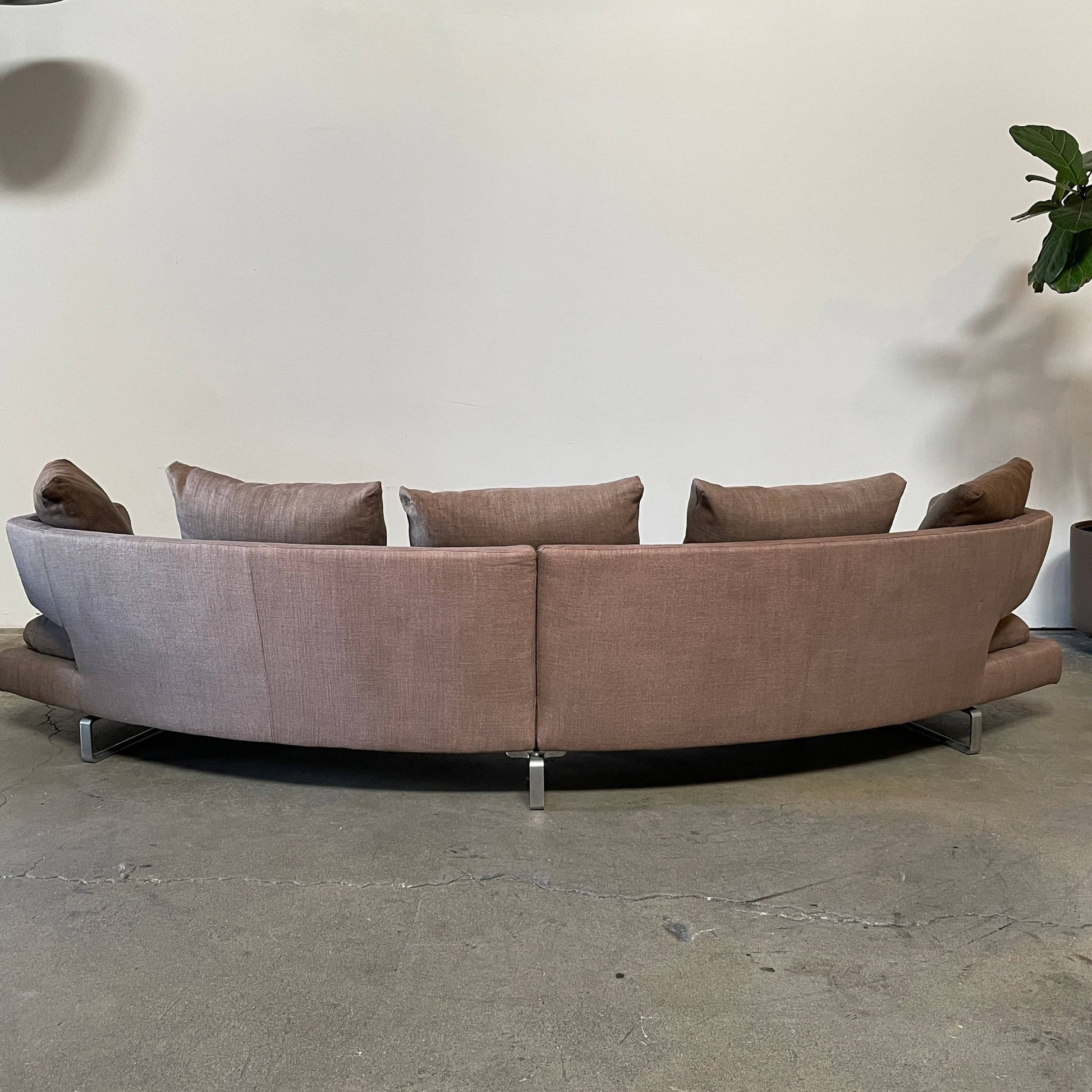 Modern upholstered l-shaped sectional B&B Italia Arne Sofa designed by Antonio Citterio, with cushions on a white background.