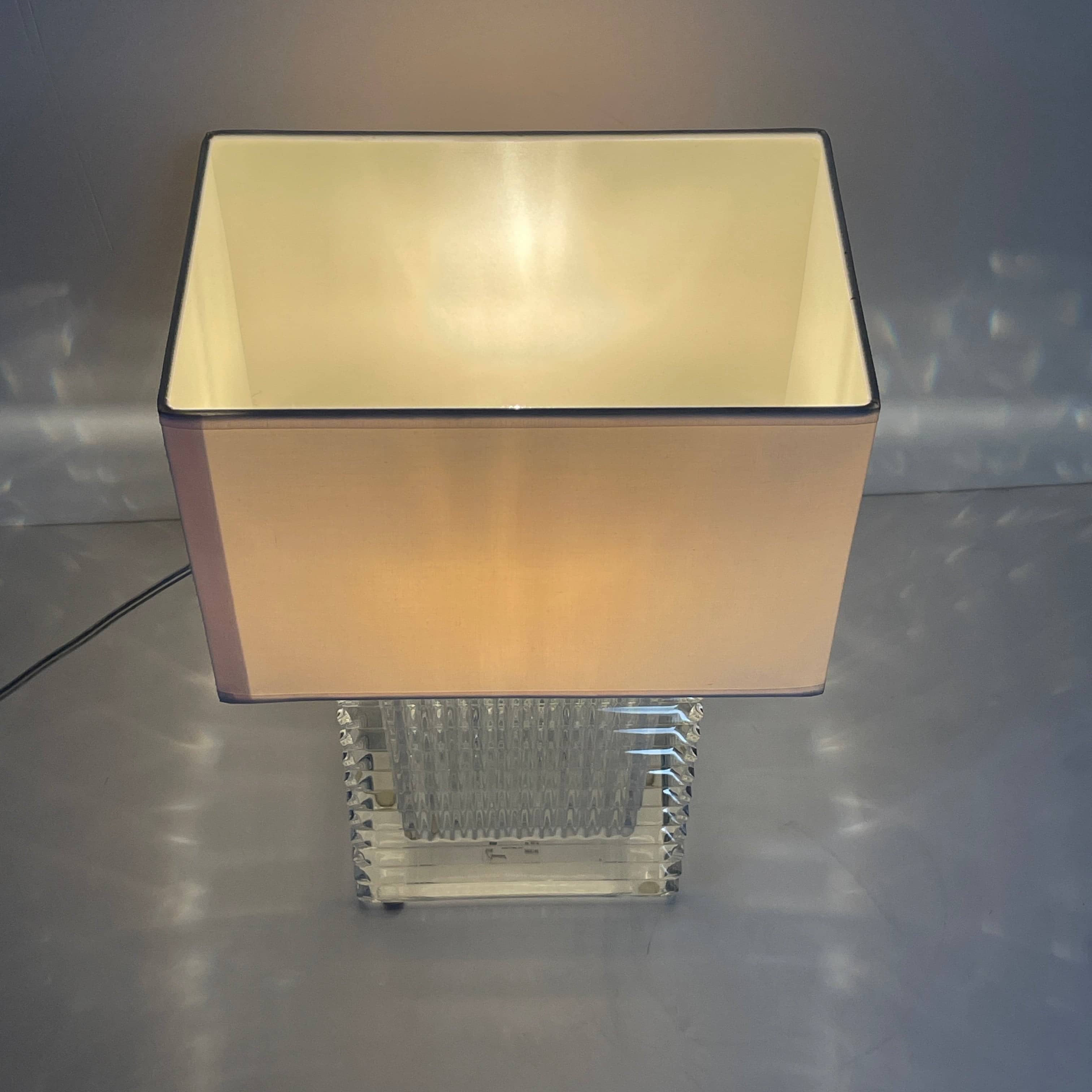 An elegant Baccarat Eye Table Lamp with a white shade designed by Nicolas Triboulot.