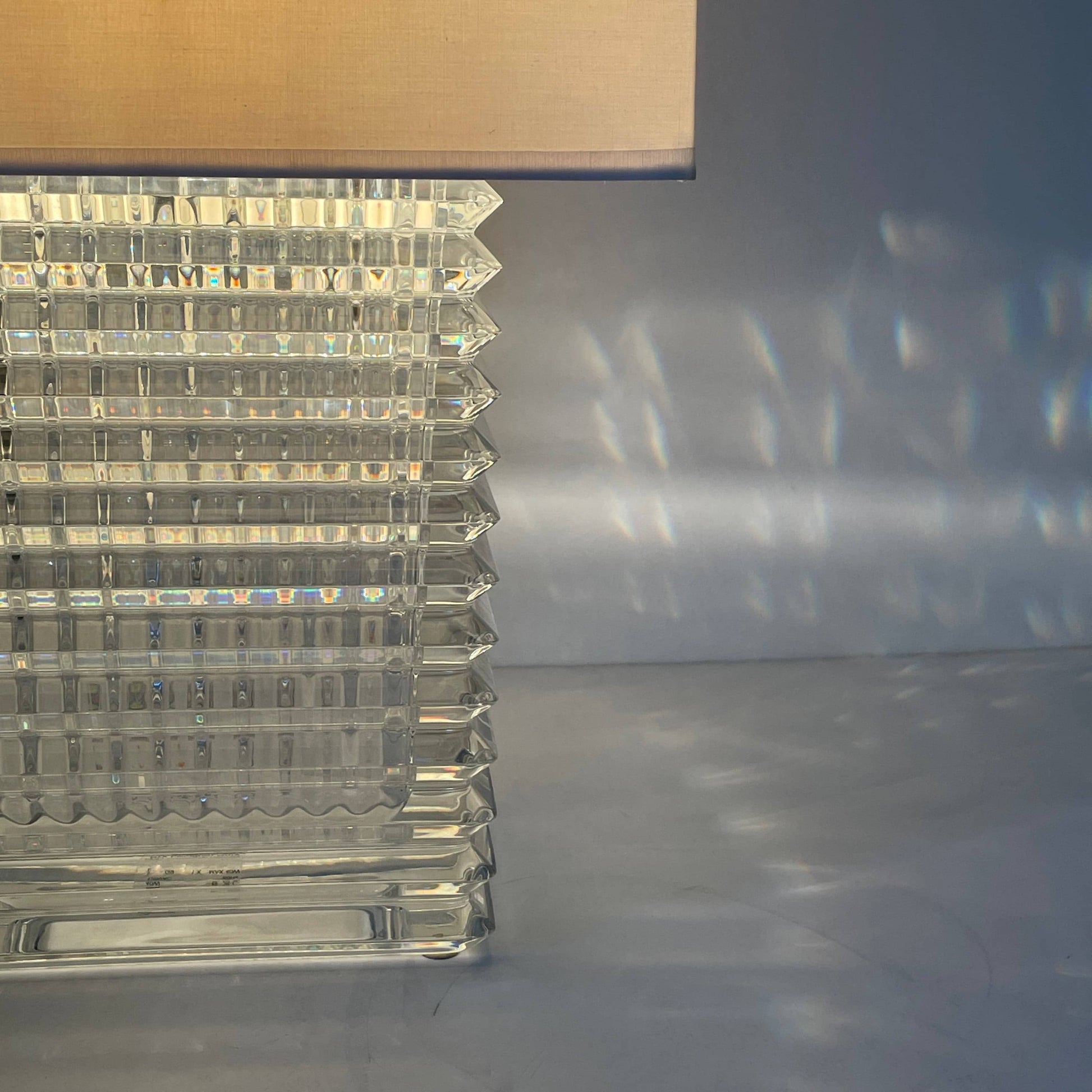 An elegant Baccarat Eye Table Lamp with a white shade designed by Nicolas Triboulot.