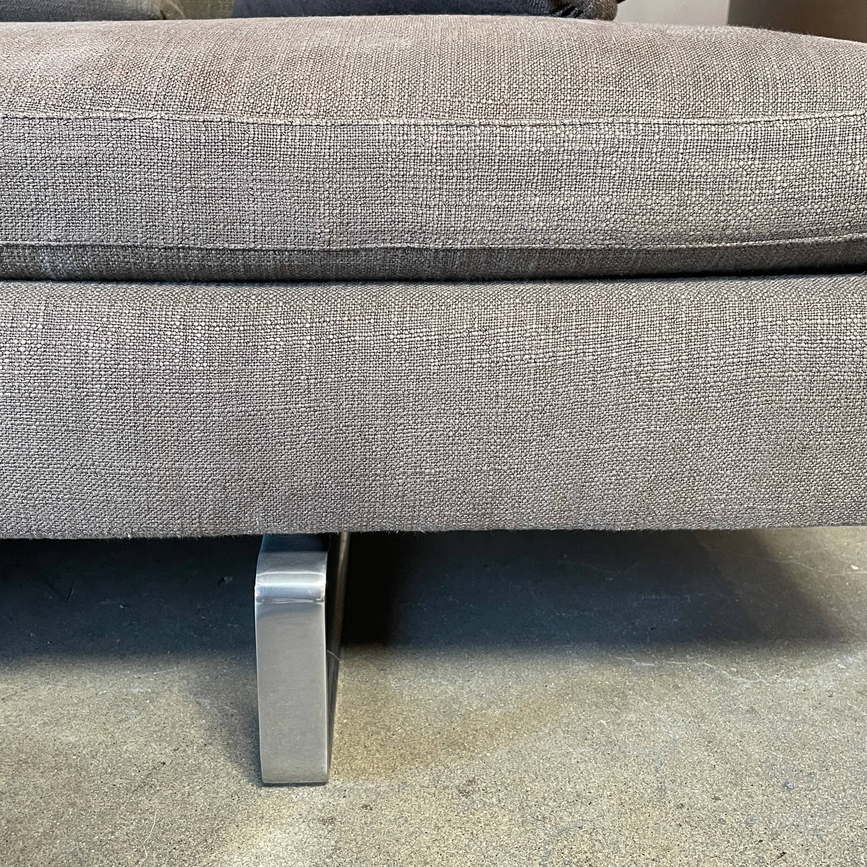 Modern upholstered l-shaped sectional B&B Italia Arne Sofa designed by Antonio Citterio, with cushions on a white background.