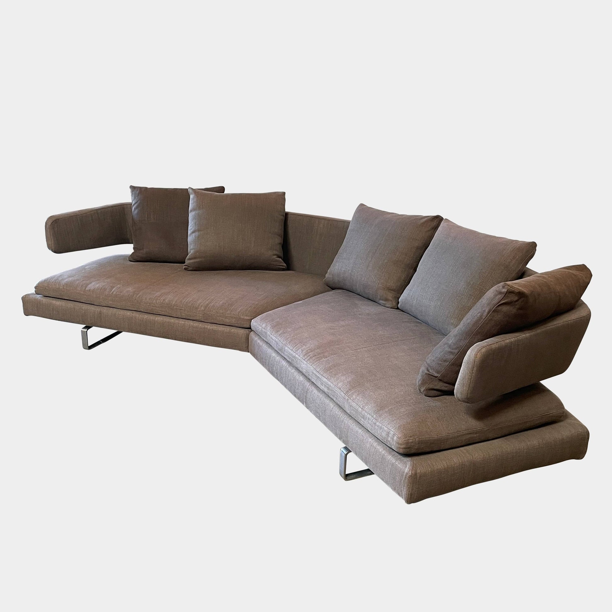 Modern upholstered l-shaped sectional B&B Italia Arne Sofa designed by Antonio Citterio, with cushions on a white background.