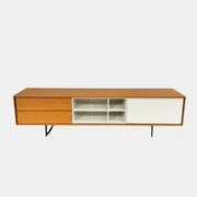 The Treku Aura Media Console by Treku features black metal legs, three left drawers, four open white center shelves, and a right white cabinet door—ideal for minimalist design and organizing your media equipment.