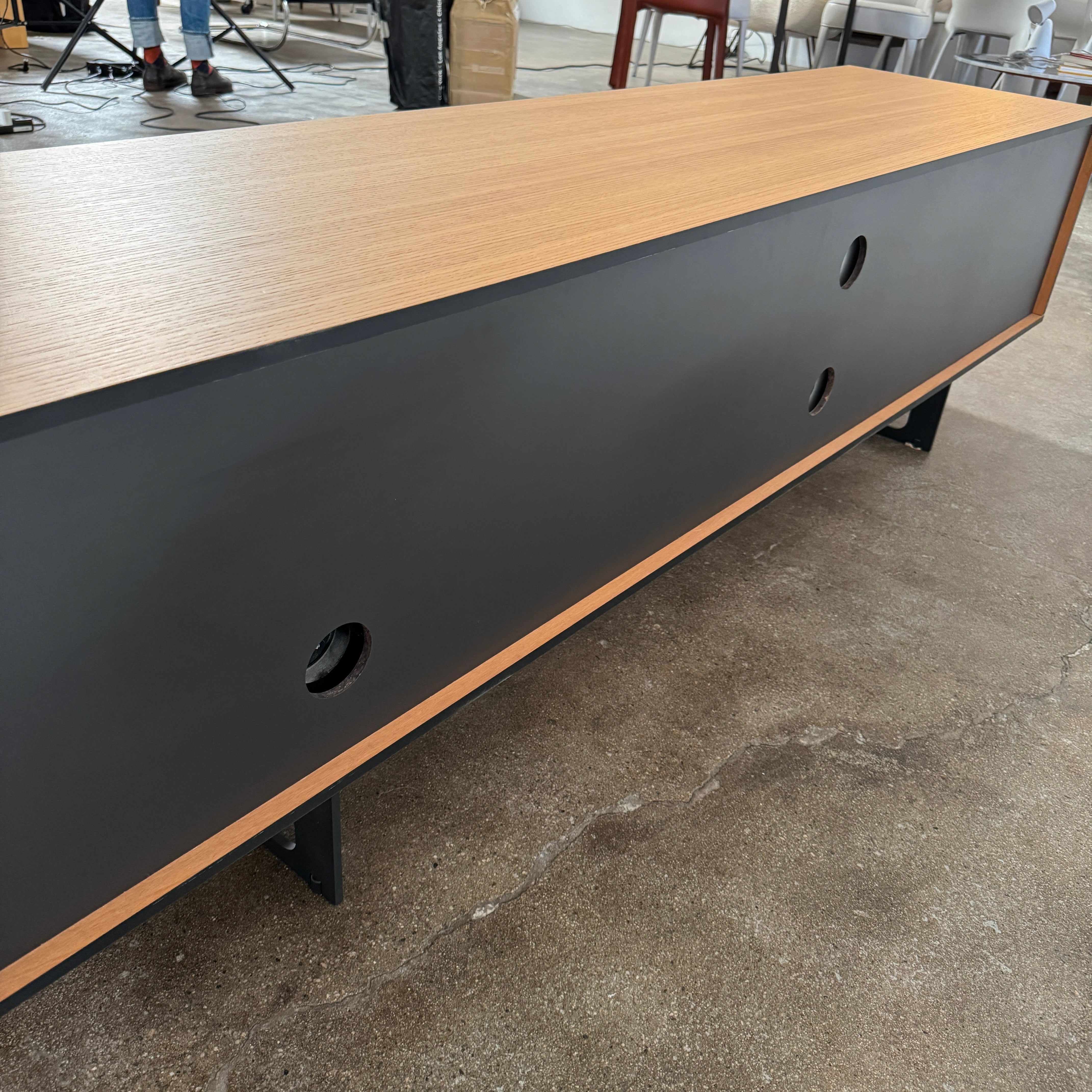 The Treku Aura Media Console by Treku features black metal legs, three left drawers, four open white center shelves, and a right white cabinet door—ideal for minimalist design and organizing your media equipment.