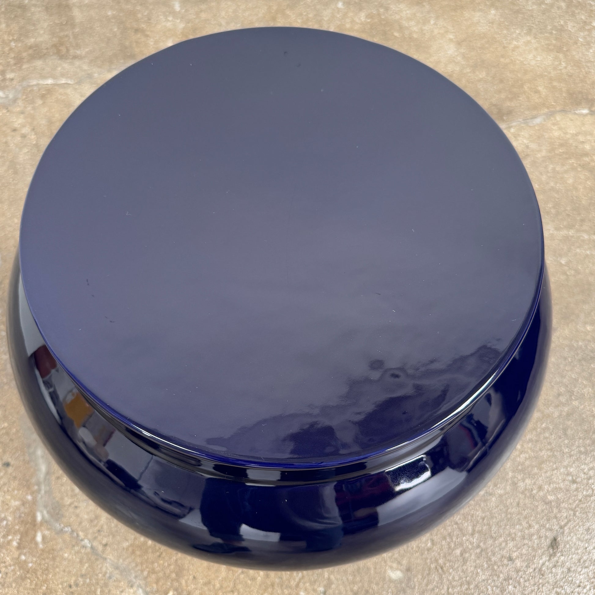 The Delcourt Collection Dot table by Delcourt Collection, designed by Charles Kalpakian, features a glossy ultramarine blue glaze and a dark blue cylindrical form with a wide, rounded top edge, set against a plain white background.