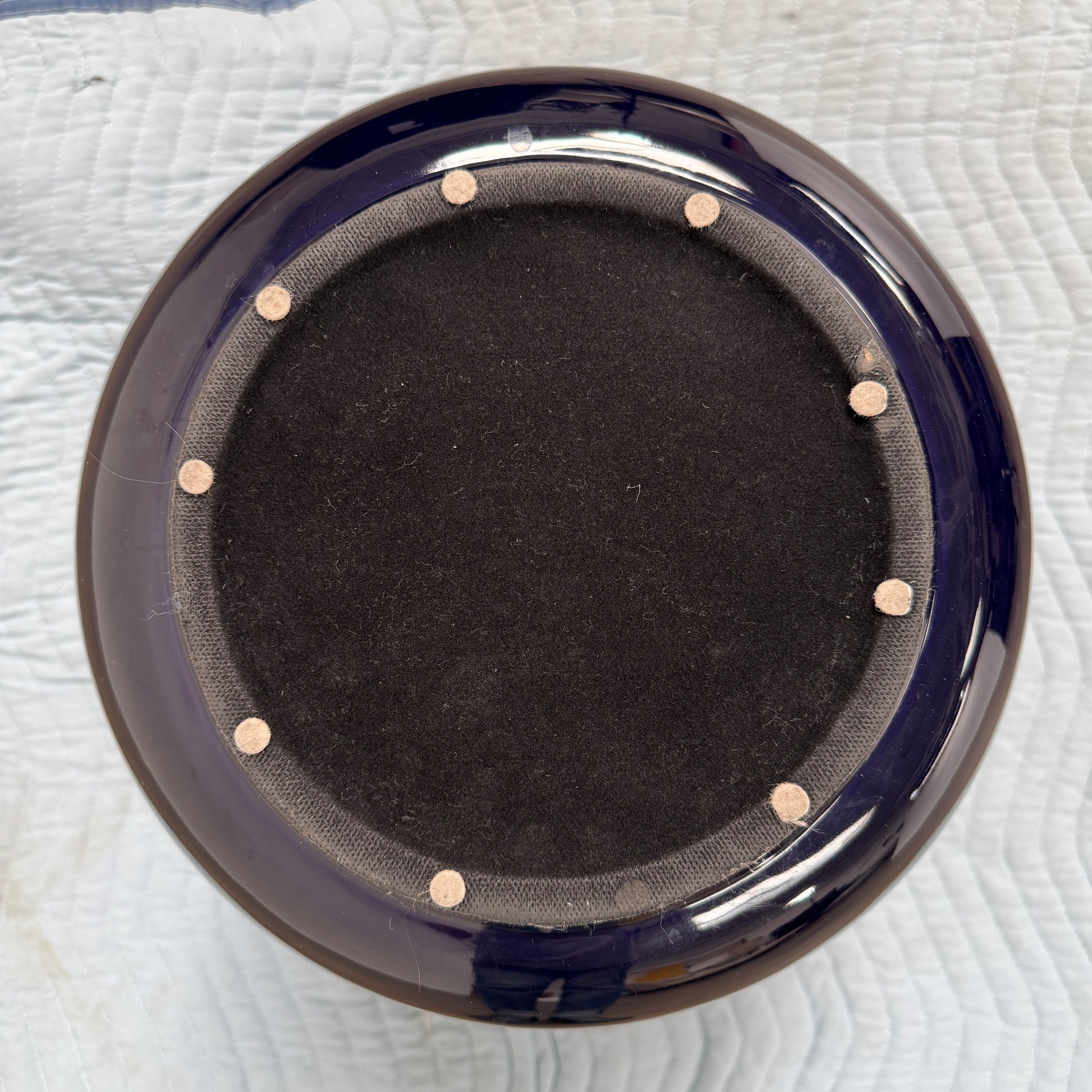The Delcourt Collection Dot table by Delcourt Collection, designed by Charles Kalpakian, features a glossy ultramarine blue glaze and a dark blue cylindrical form with a wide, rounded top edge, set against a plain white background.