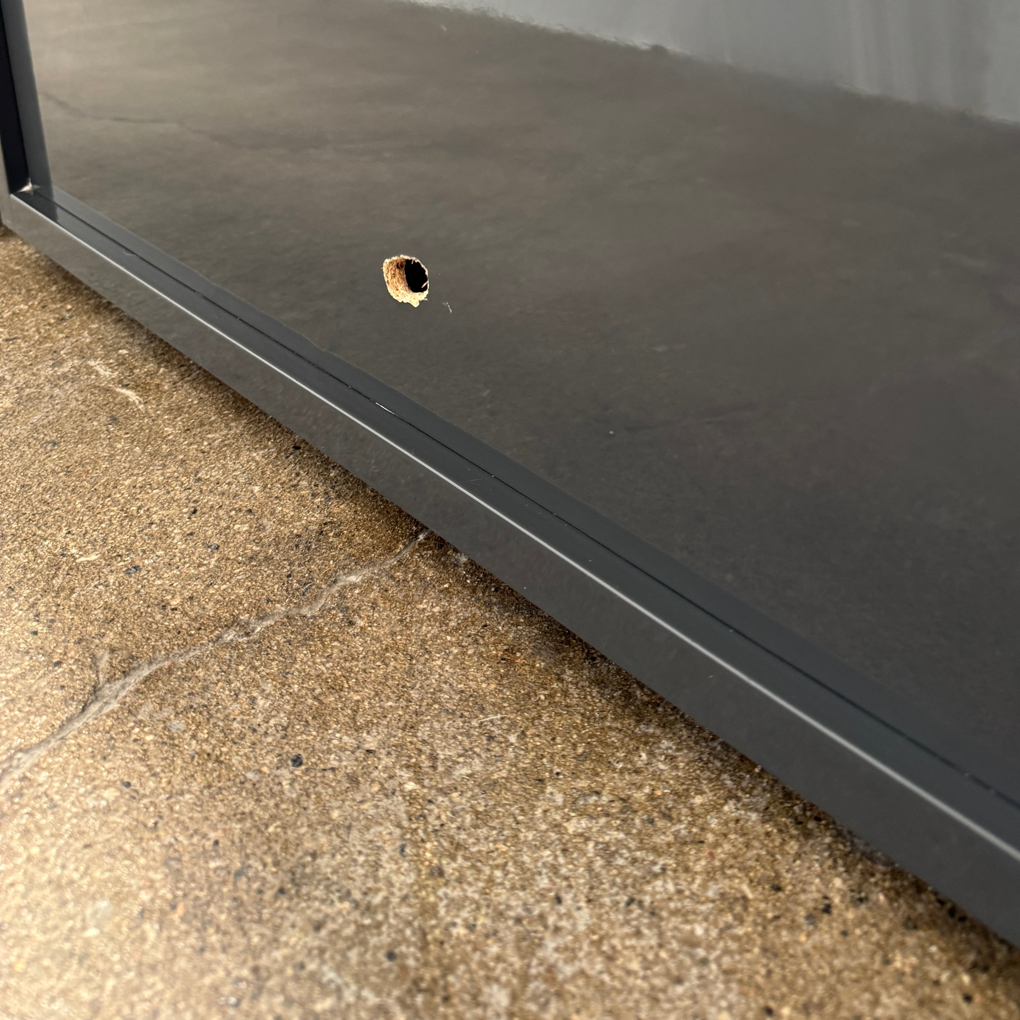 A pair of Poliform Dream Night Stands, each dark and rectangular with three drawers, stand side by side on a concrete floor against a plain white wall.