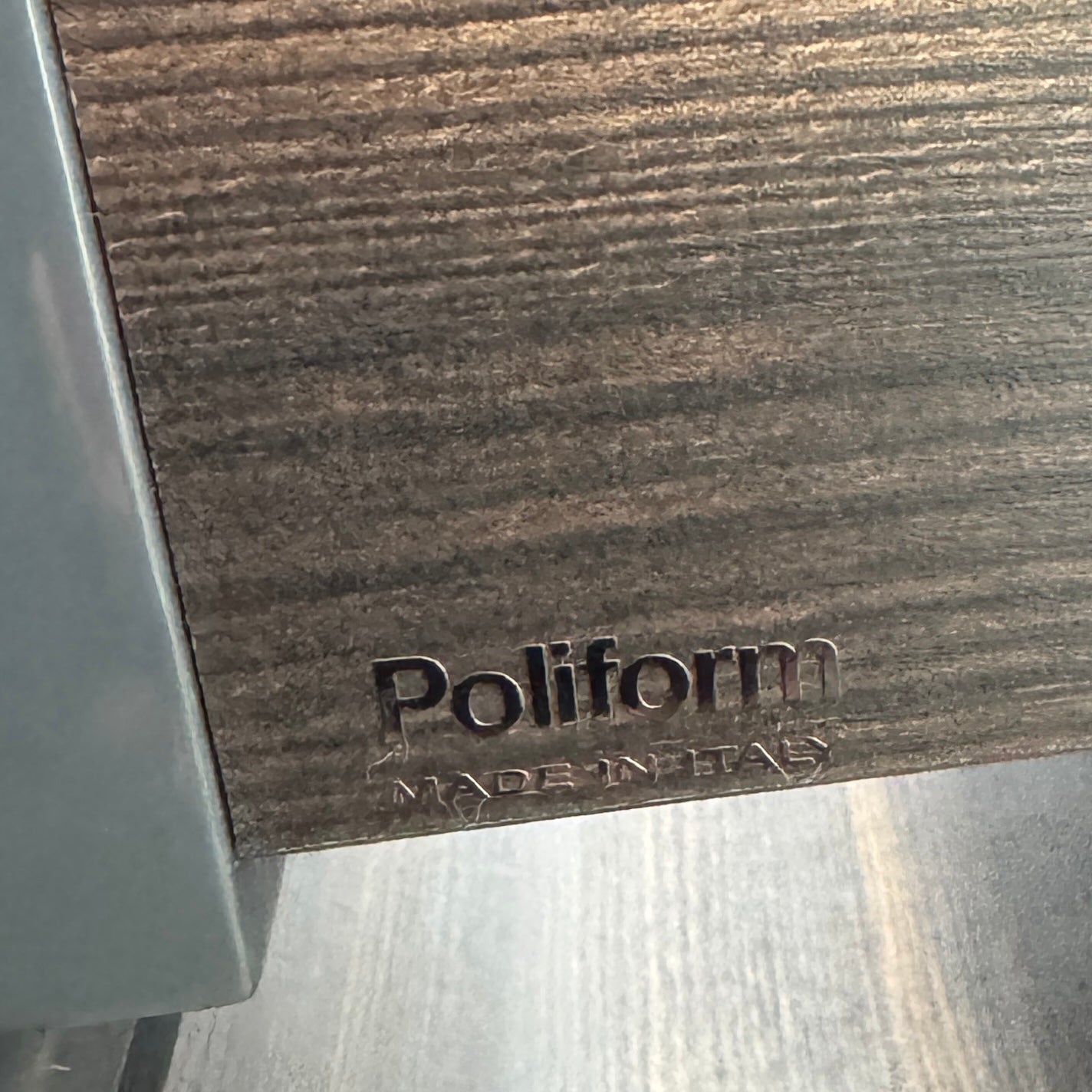 A pair of Poliform Dream Night Stands, each dark and rectangular with three drawers, stand side by side on a concrete floor against a plain white wall.