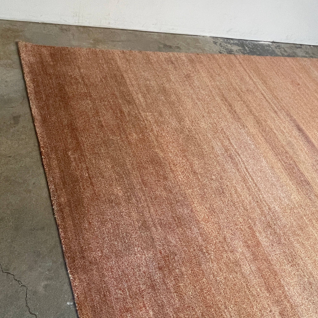 A Delinear Speckled 8' x 10' Rug with a brown color on a white background made from New Zealand wool.