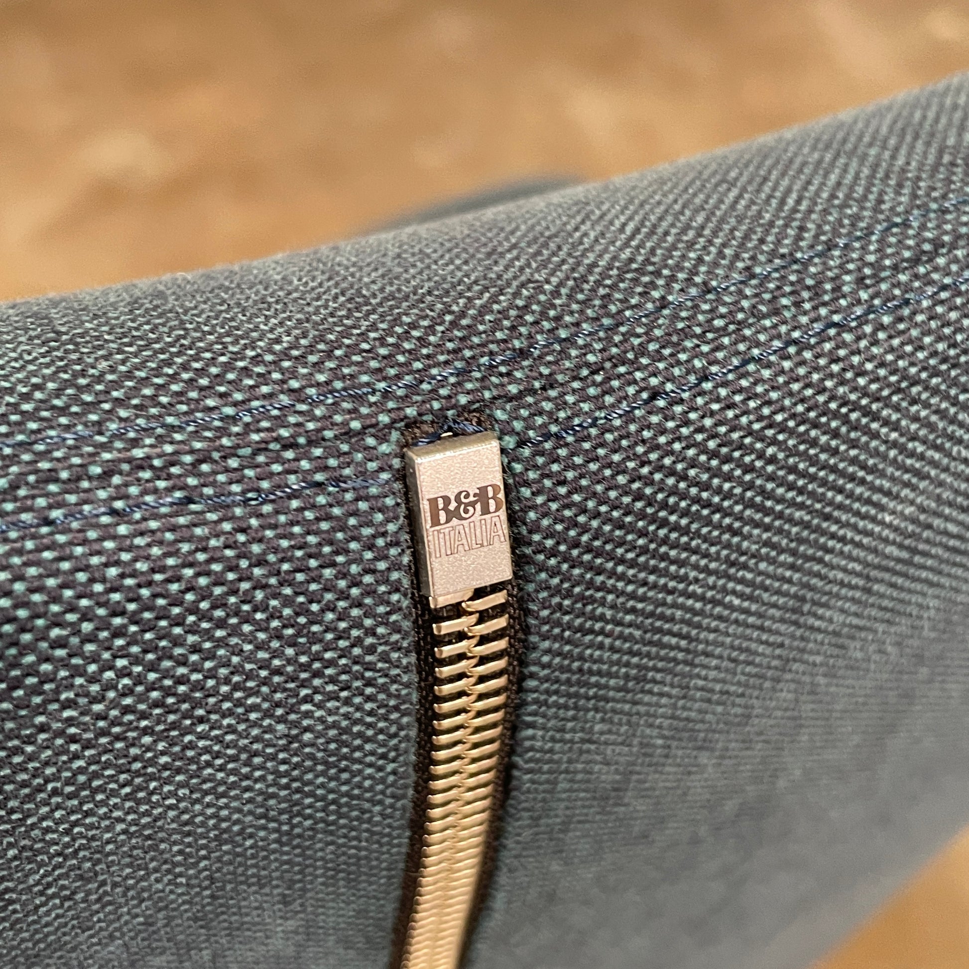 The B&B Italia Grande Papilio Swivel Chair with Ottoman features a modern design inspired by Naoto Fukasawa, with a dark blue finish, wide seat, curved armrests, and a high winged backrest—a signature piece from B&B Italia.