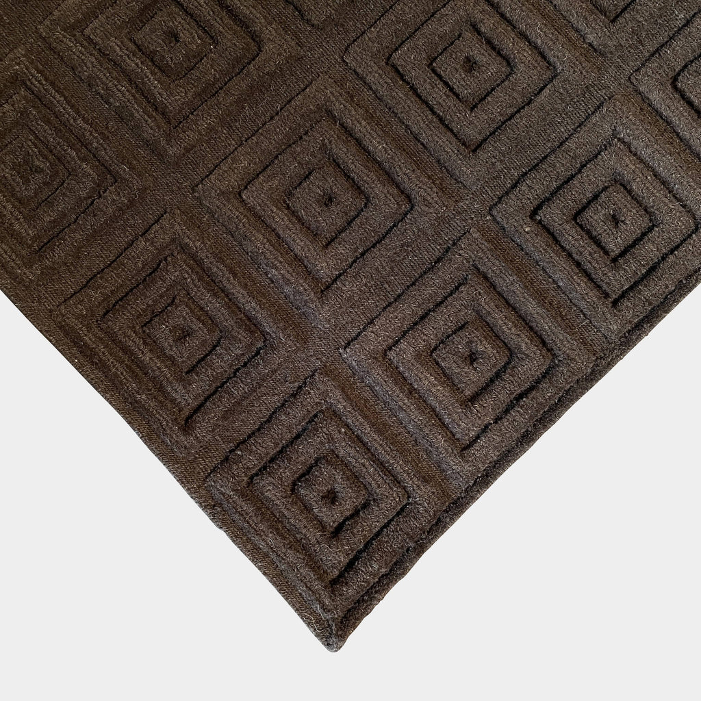 A brown Delinear rug with squares made of pure Himalayan wool.