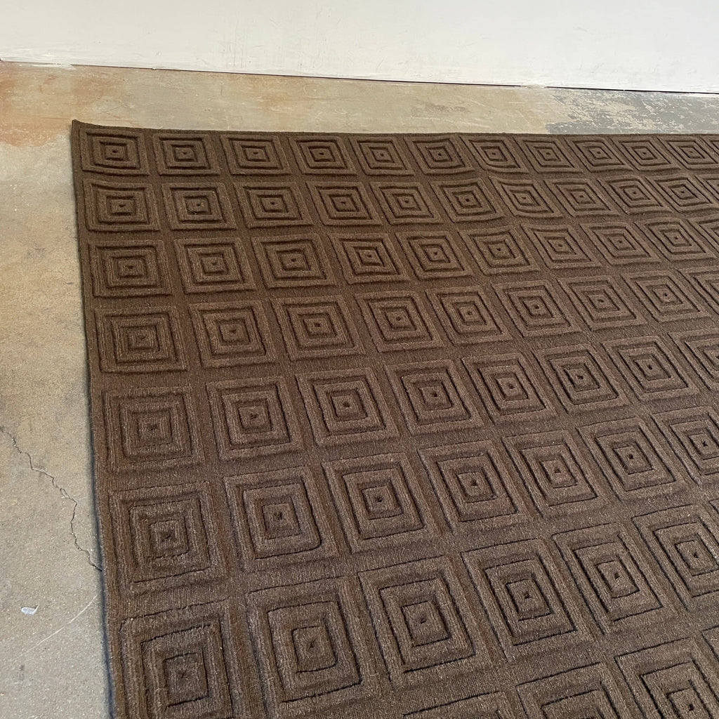 A brown Delinear rug with squares made of pure Himalayan wool.