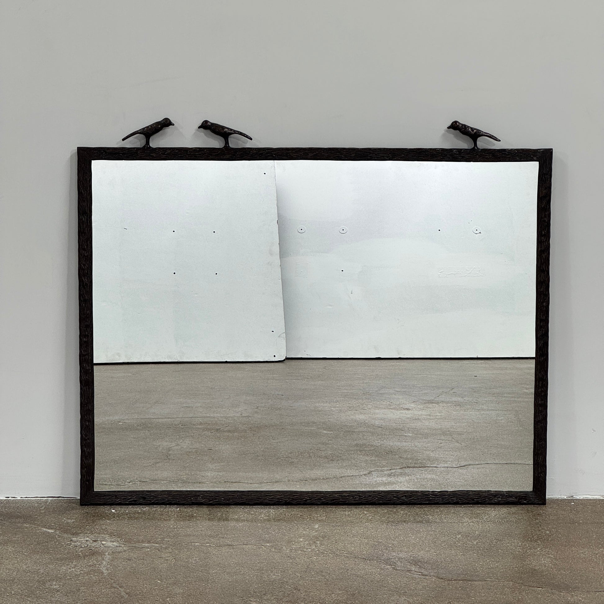 The Made Goods Joelle Three Birds Mirror is a rectangular wall mirror with a dark frame and three bird-shaped accents on its top edge, shown against a plain light background.