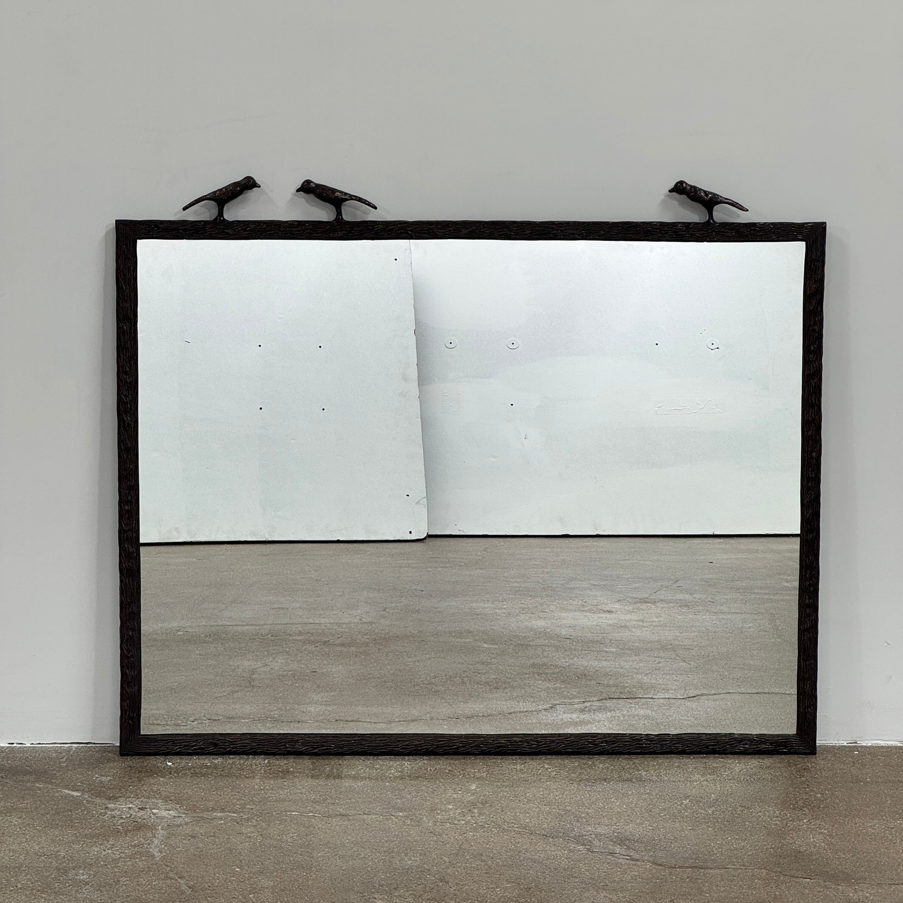 The Made Goods Joelle Three Birds Mirror is a rectangular wall mirror with a dark frame and three bird-shaped accents on its top edge, shown against a plain light background.