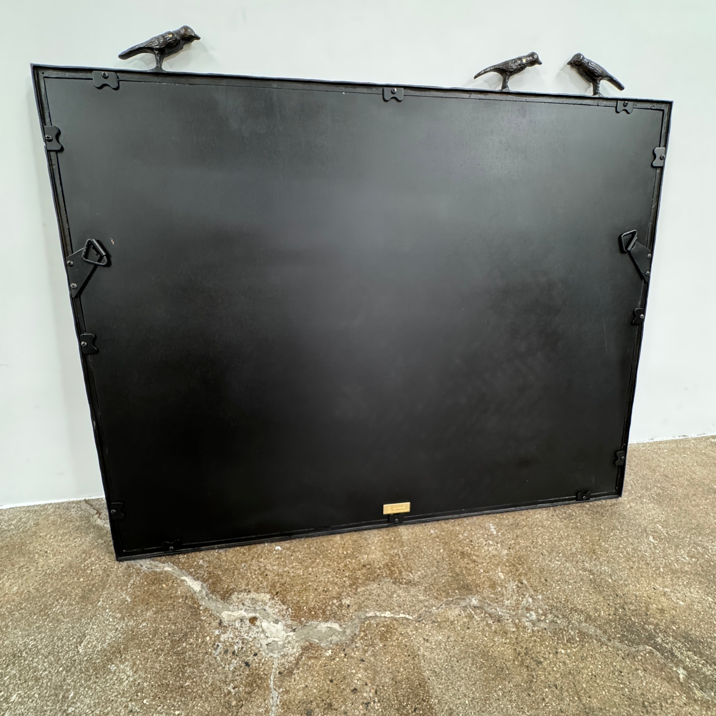 The Made Goods Joelle Three Birds Mirror is a rectangular wall mirror with a dark frame and three bird-shaped accents on its top edge, shown against a plain light background.