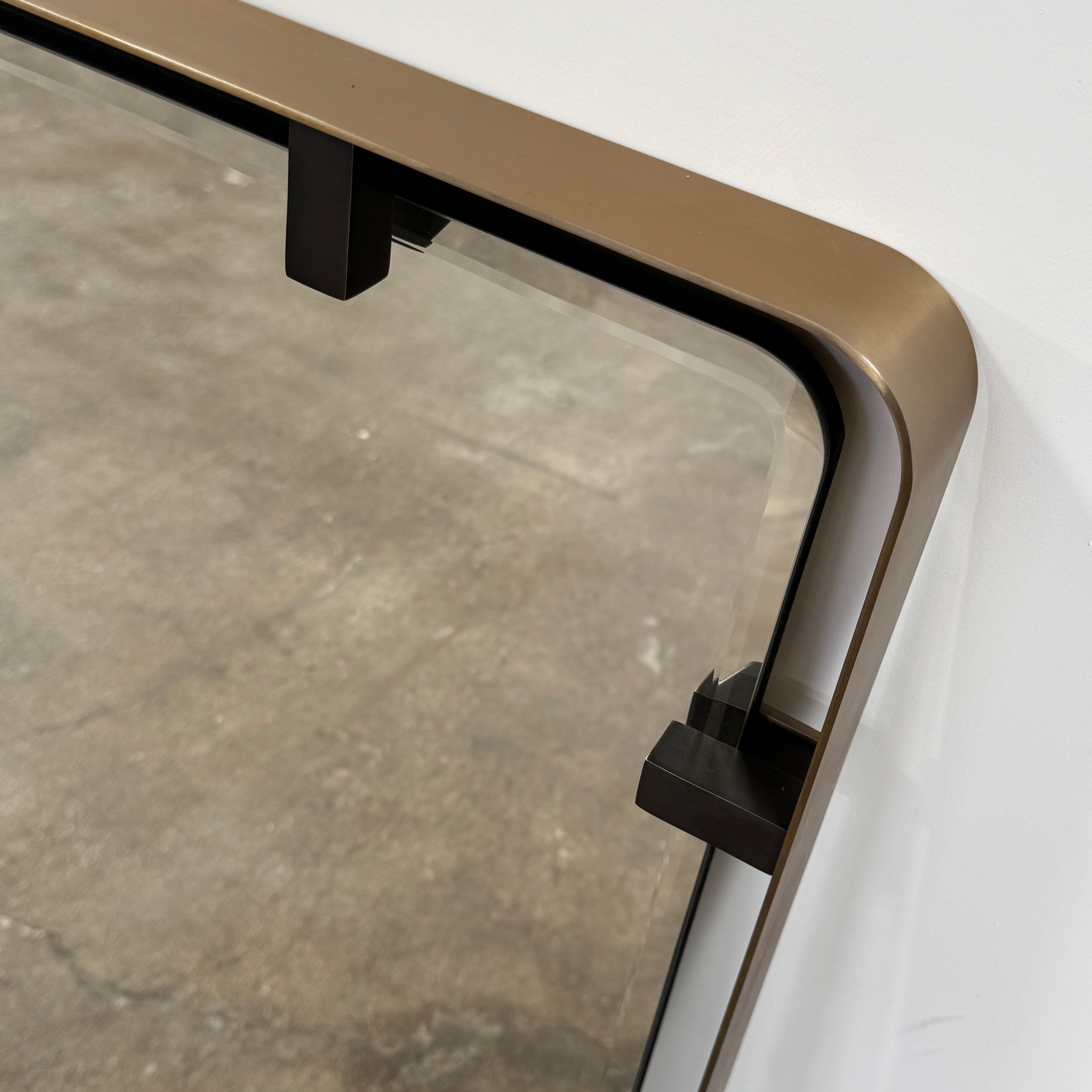 The Made Goods Fremont Mirror from Modern Resale features a rectangular design with rounded corners and a thin black shadow box frame, displayed against a plain light gray background.