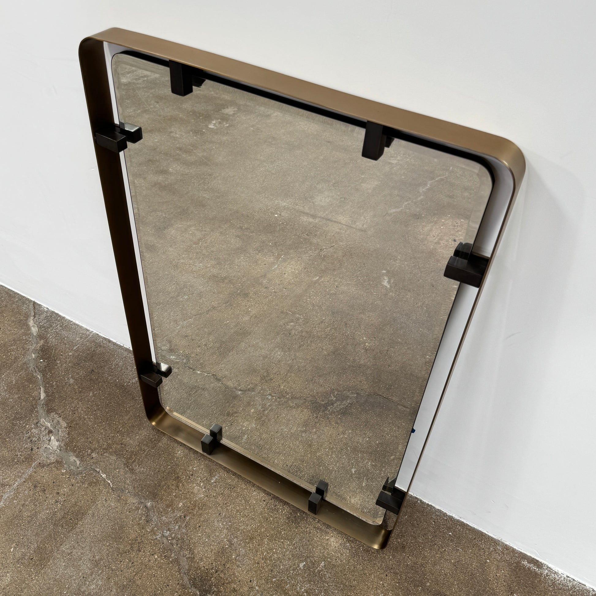 The Made Goods Fremont Mirror from Modern Resale features a rectangular design with rounded corners and a thin black shadow box frame, displayed against a plain light gray background.