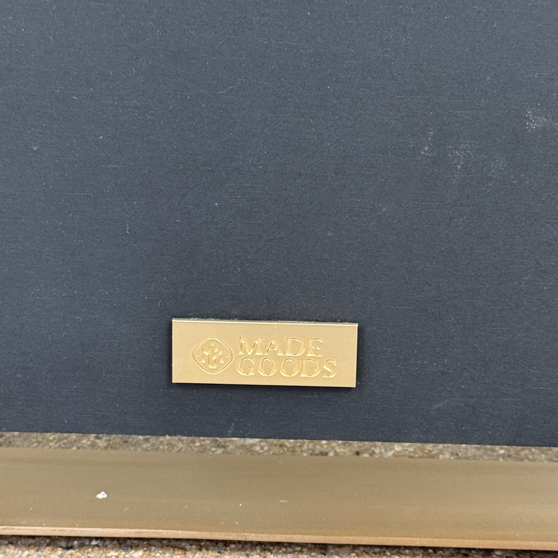 The Made Goods Fremont Mirror from Modern Resale features a rectangular design with rounded corners and a thin black shadow box frame, displayed against a plain light gray background.