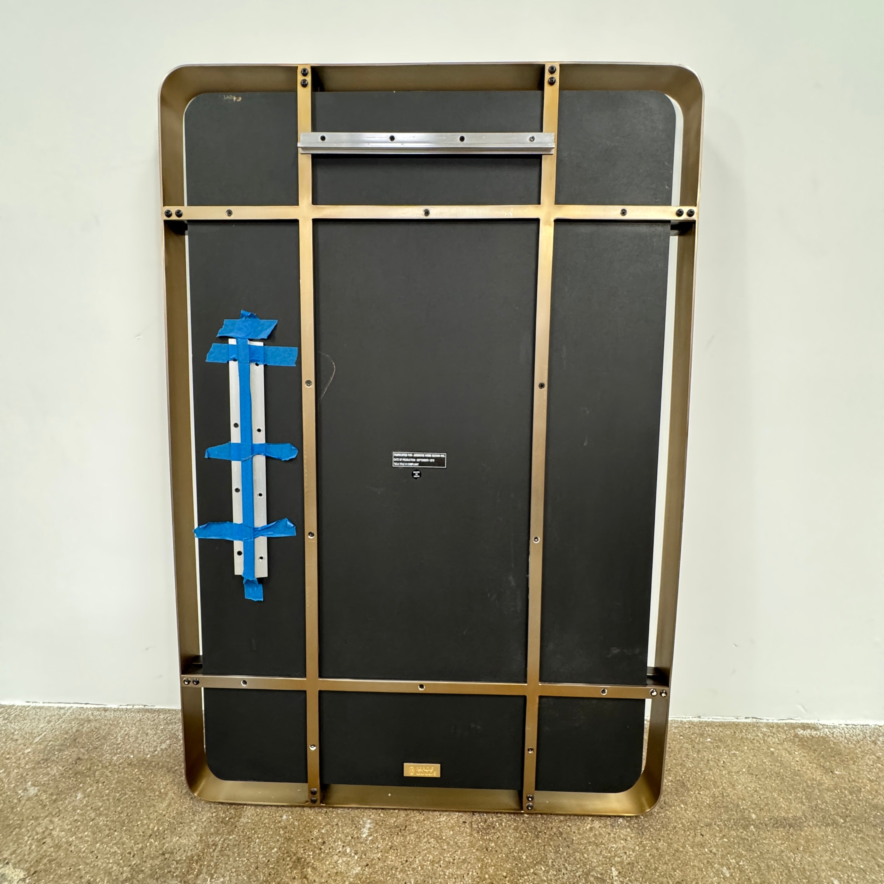 The Made Goods Fremont Mirror from Modern Resale features a rectangular design with rounded corners and a thin black shadow box frame, displayed against a plain light gray background.