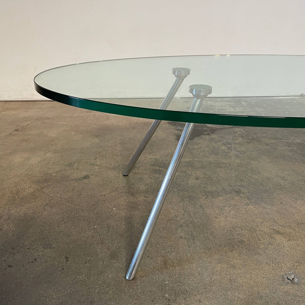 A Van Beek Maupertuus Oval coffee table with metal legs on a white background.