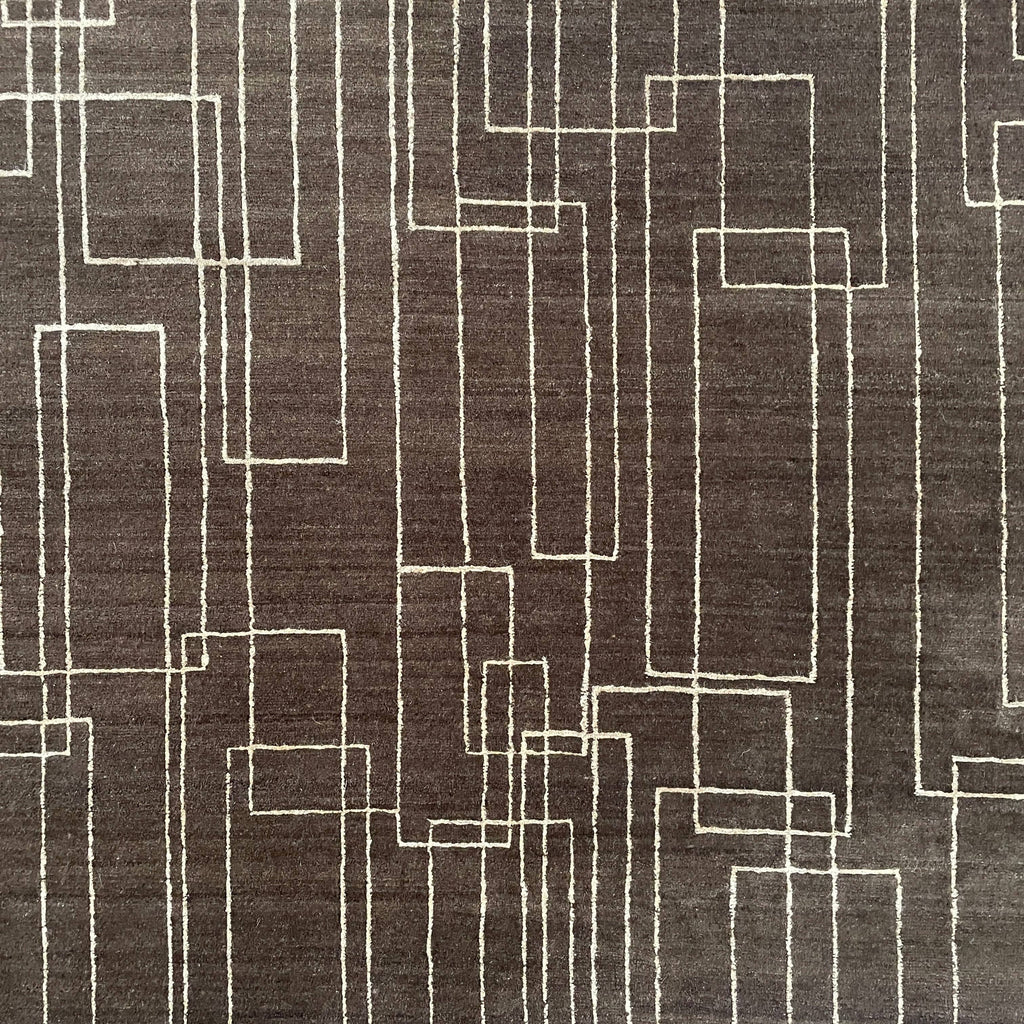 A brown Delinear Presence 8x10 wool rug with geometric lines on it.