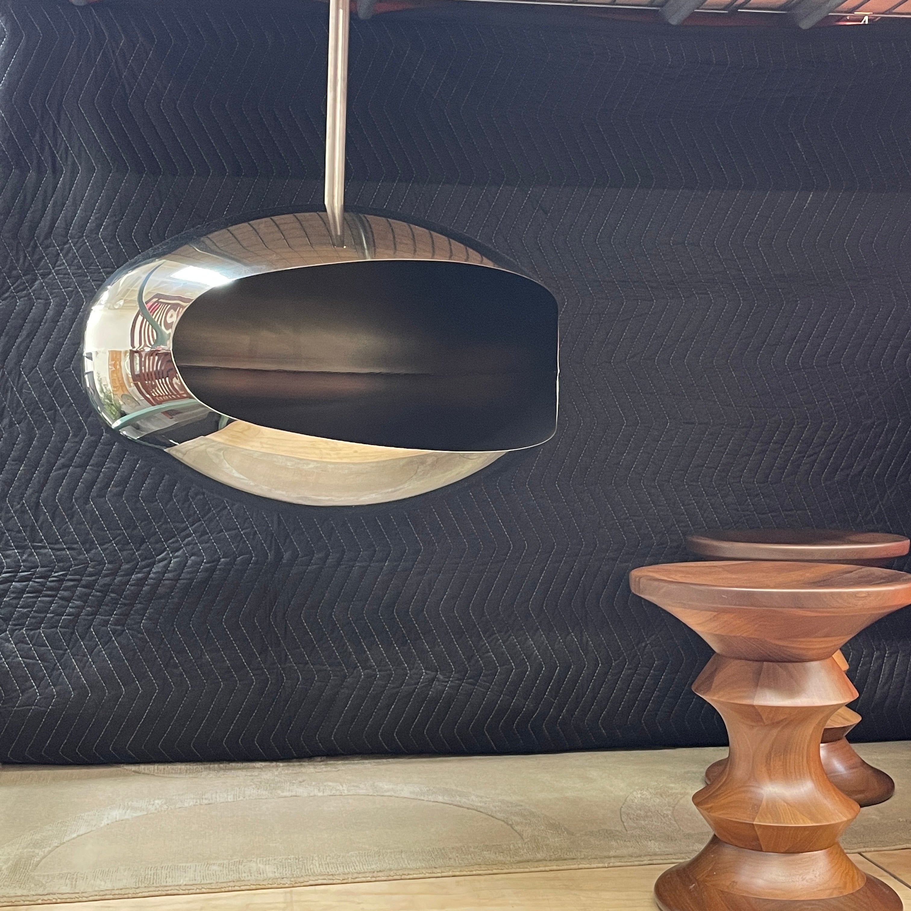 The Plushpod Cocoon Hanging Fireplace is a modern marvel with its oval design, sleek metallic finish, and reflective surface. Its rectangular opening radiates warmth and adds style to any space.